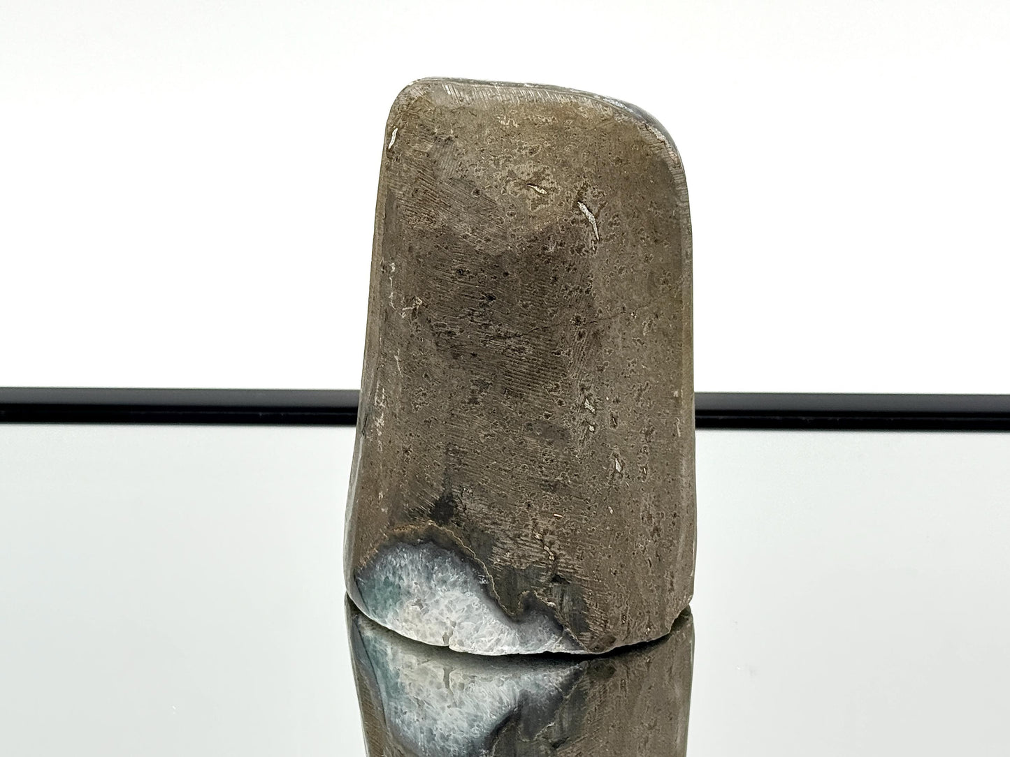 Large Uruguayan Amethyst Crystal Geode on mirror surface showcasing its polished surface and unique design.