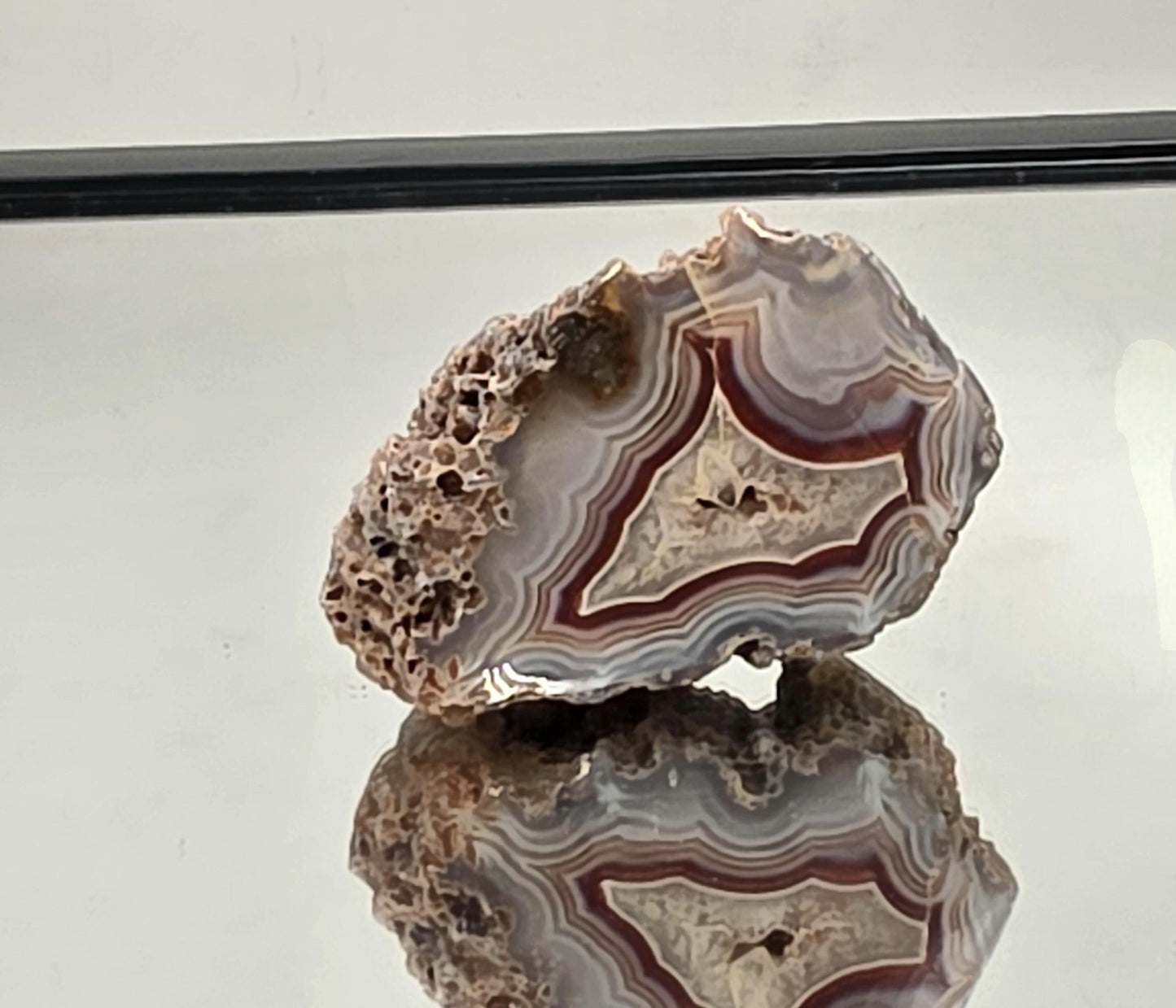 Rare Malawi Agate polished geode with colourful layers.