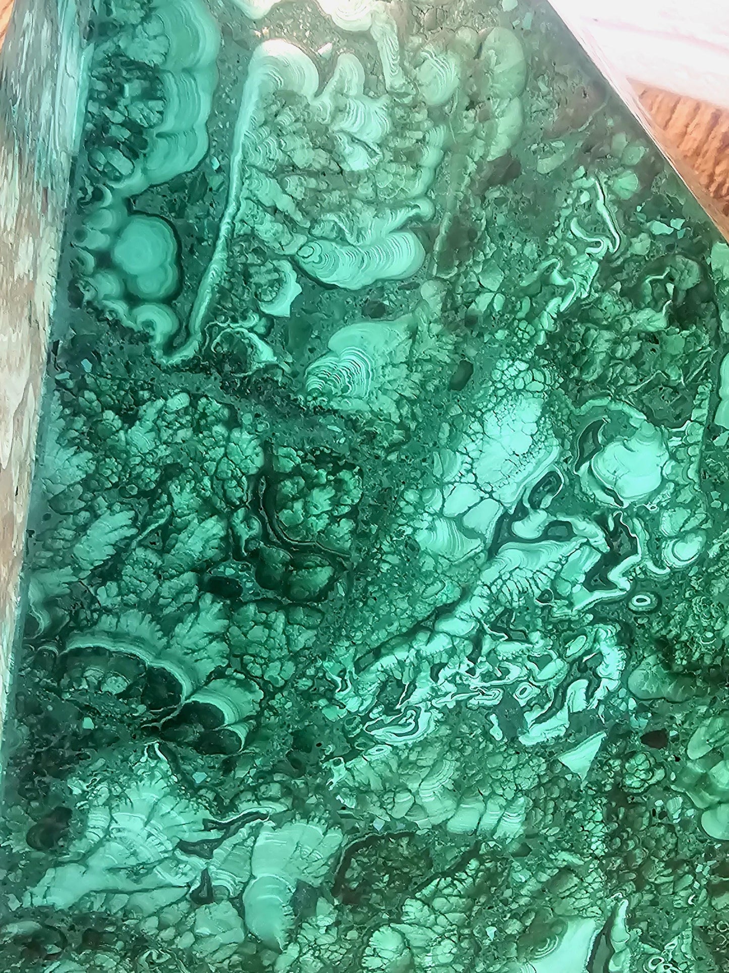 Artisanal malachite pyramid expertly crafted for refined spaces.