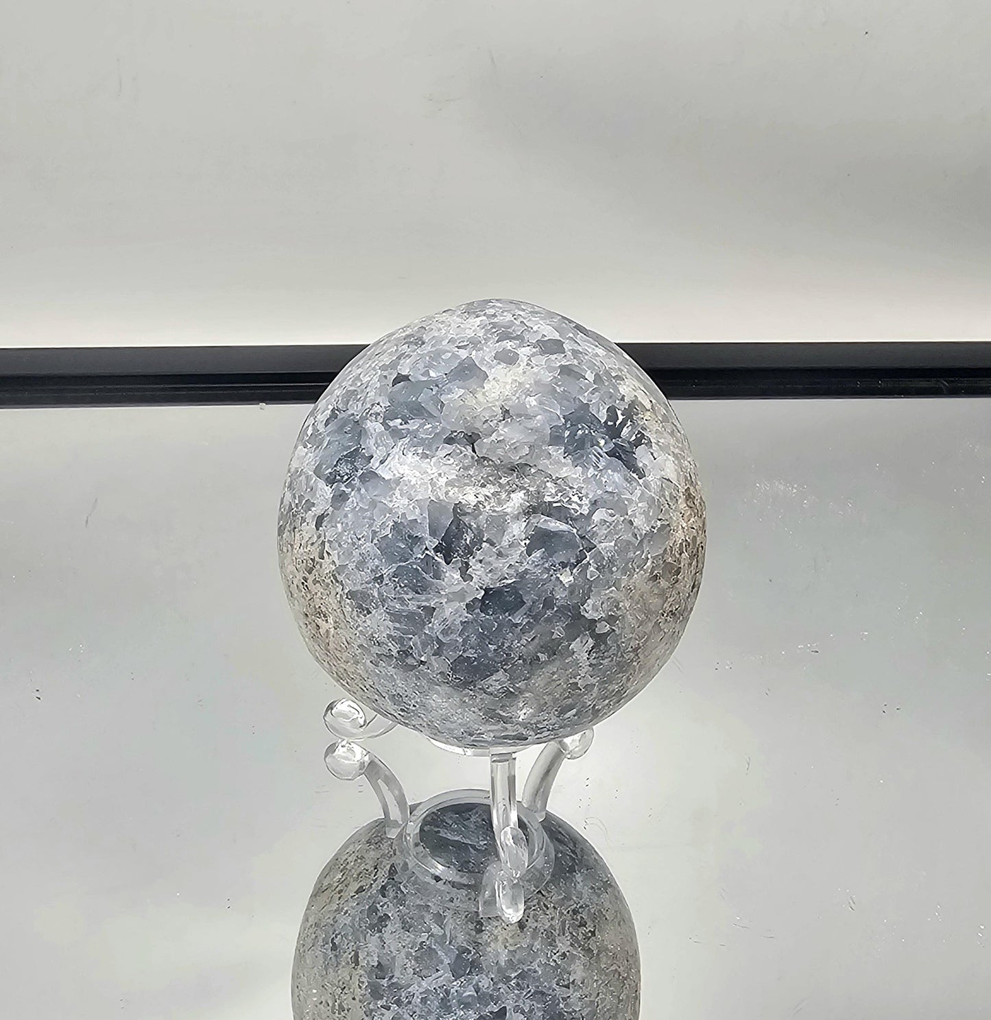 Blue Celestite Sphere used for crystal healing and meditation practices.