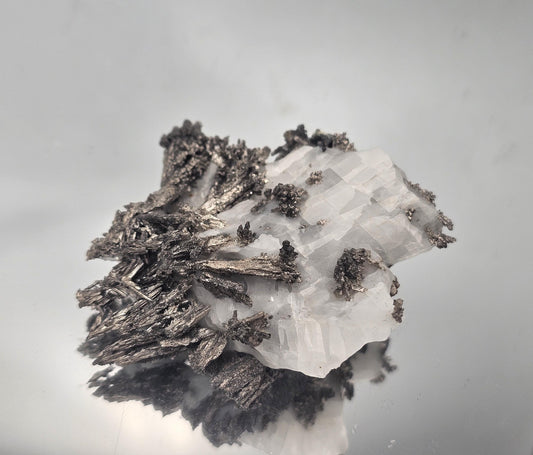 Unique collectible of Native Silver on Calcite Matrix with stunning metallic formations.