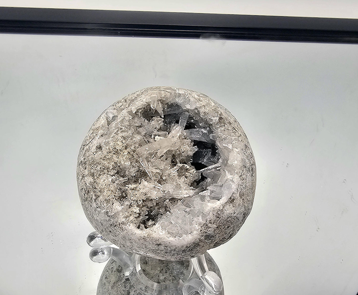Exquisite Celestite geode sphere with fine needle crystals, a unique and beautiful piece for any luxury crystal collection.