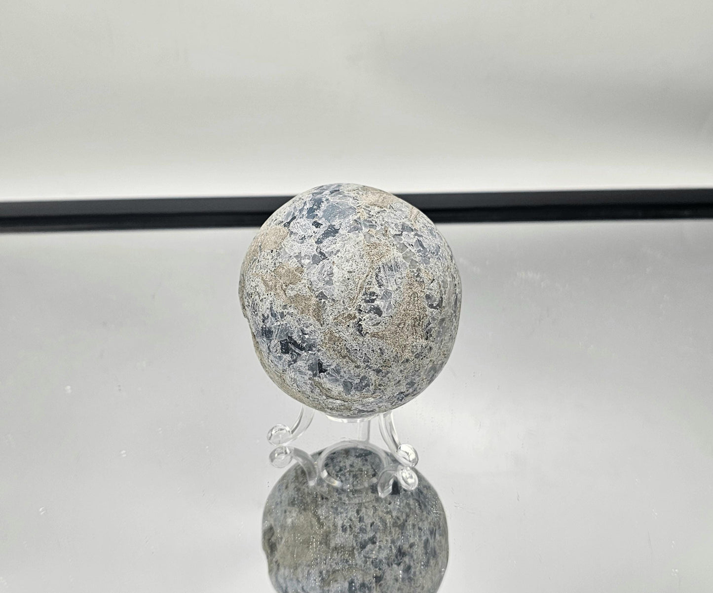 Blue Celestite Crystal sphere featuring intricate crystal clusters.