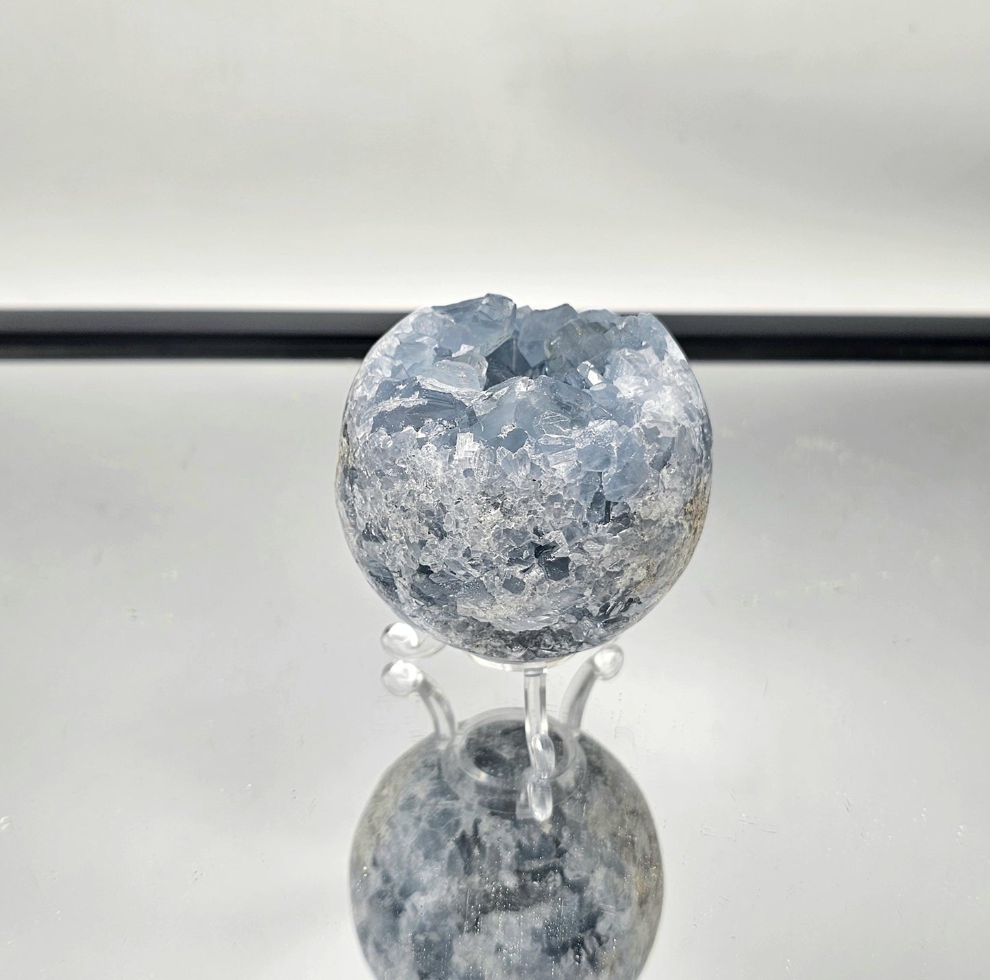 Celestite Crystal Sphere known for its calming energy and soothing blue hues.