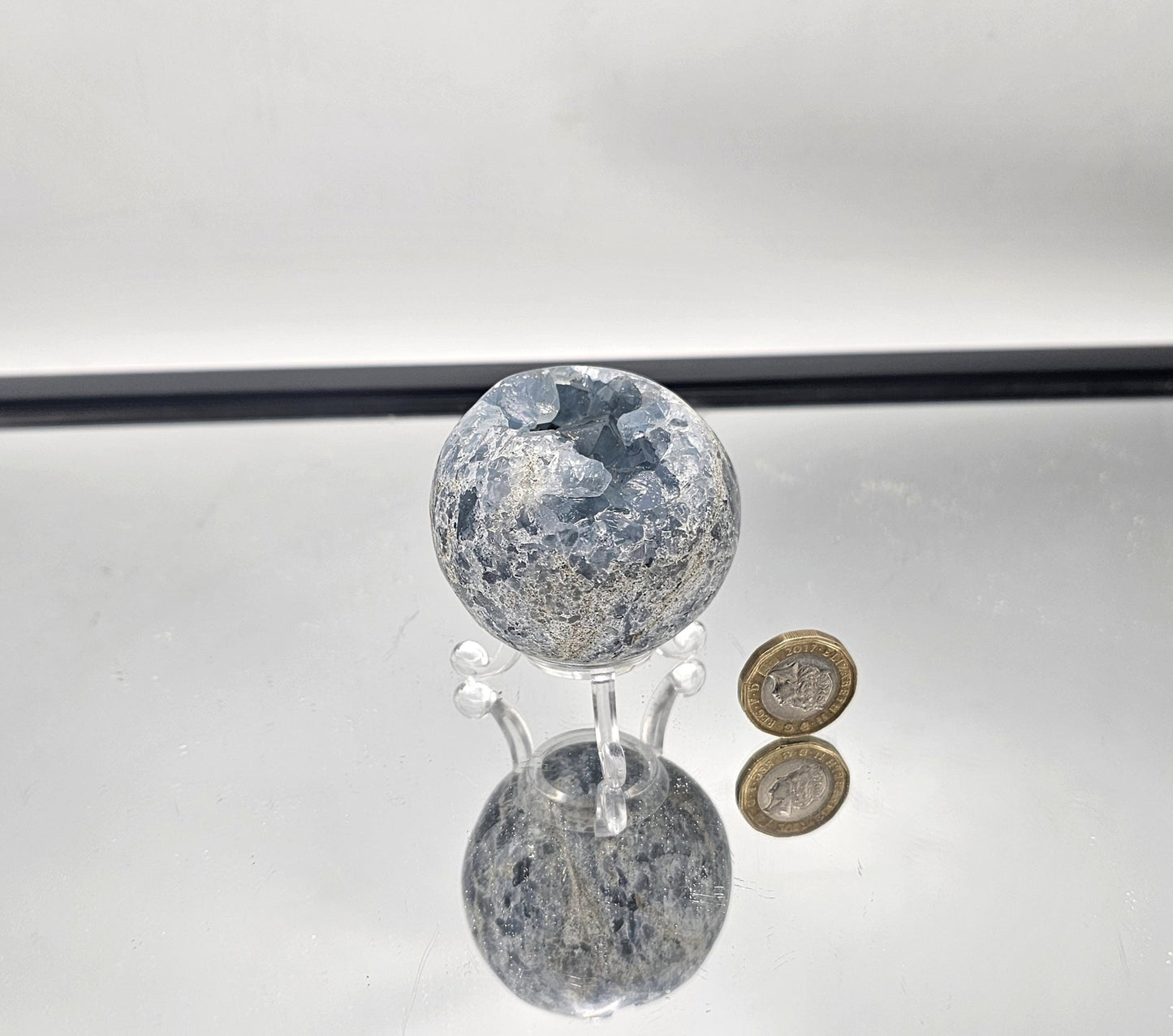 Minimalist décor with a soft blue Celestite Sphere.