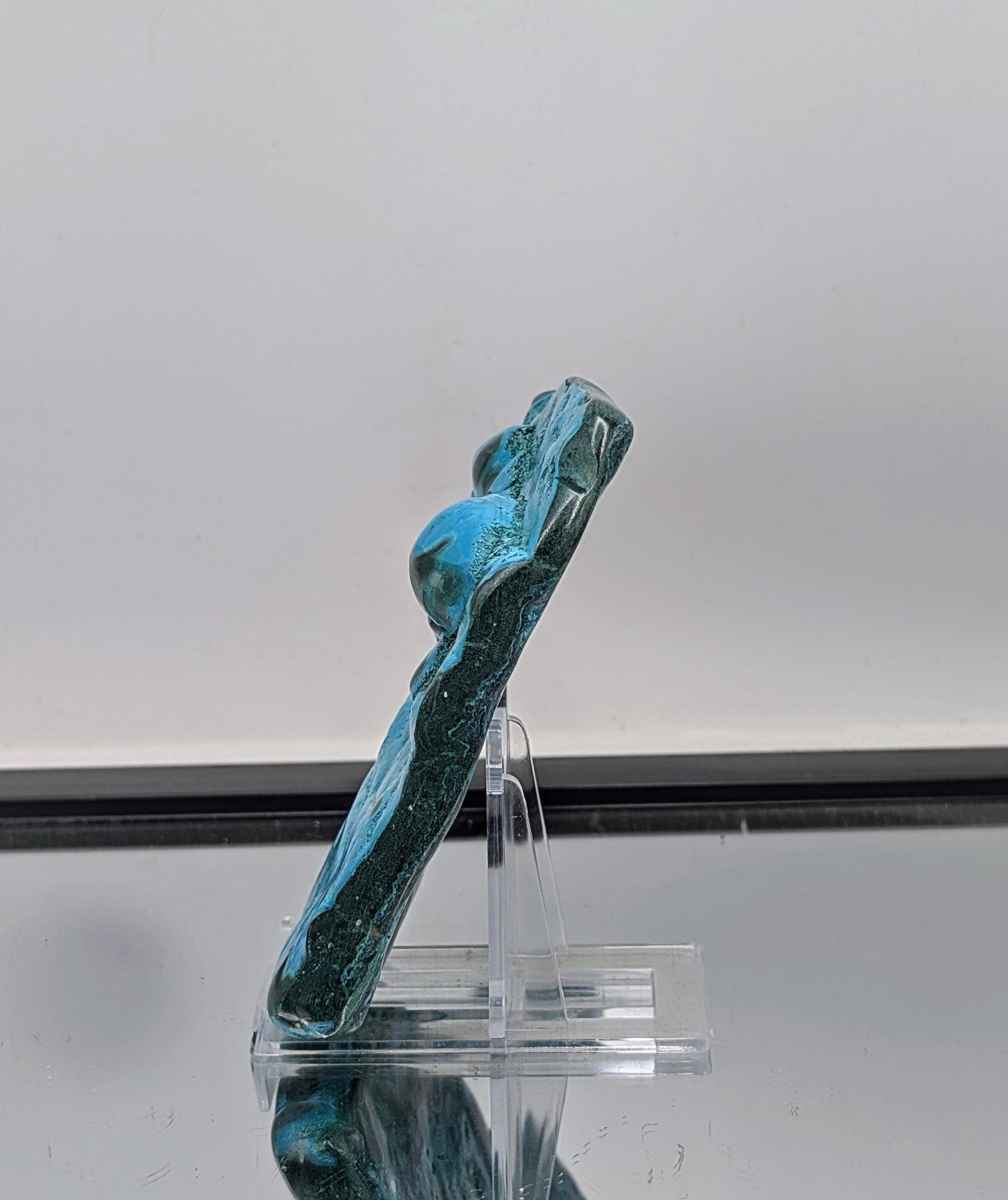 large freeform crystal combining chrysocolla and malachite with polished finish.