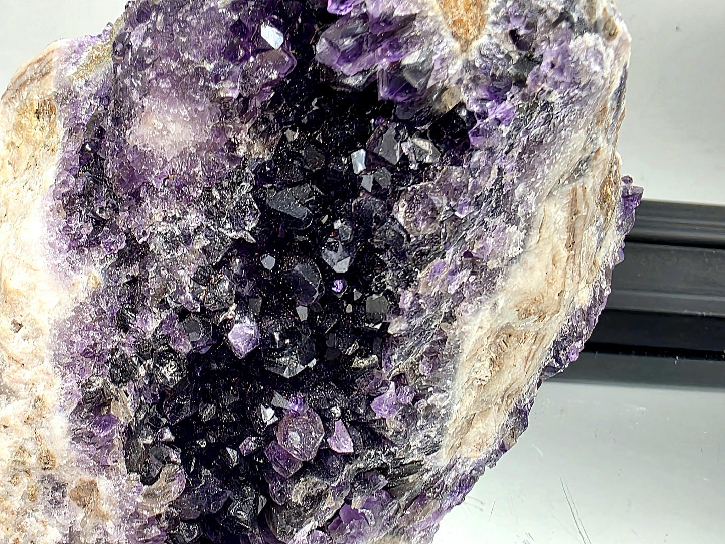 Dark violet Mapatizya amethyst cluster for display.