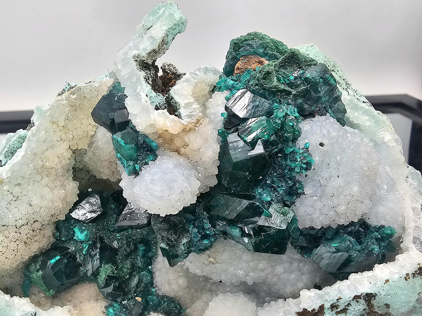 Beautiful Dioptase crystal specimen sitting on a Quartz matrix, showing off its brilliant green hue and natural beauty.