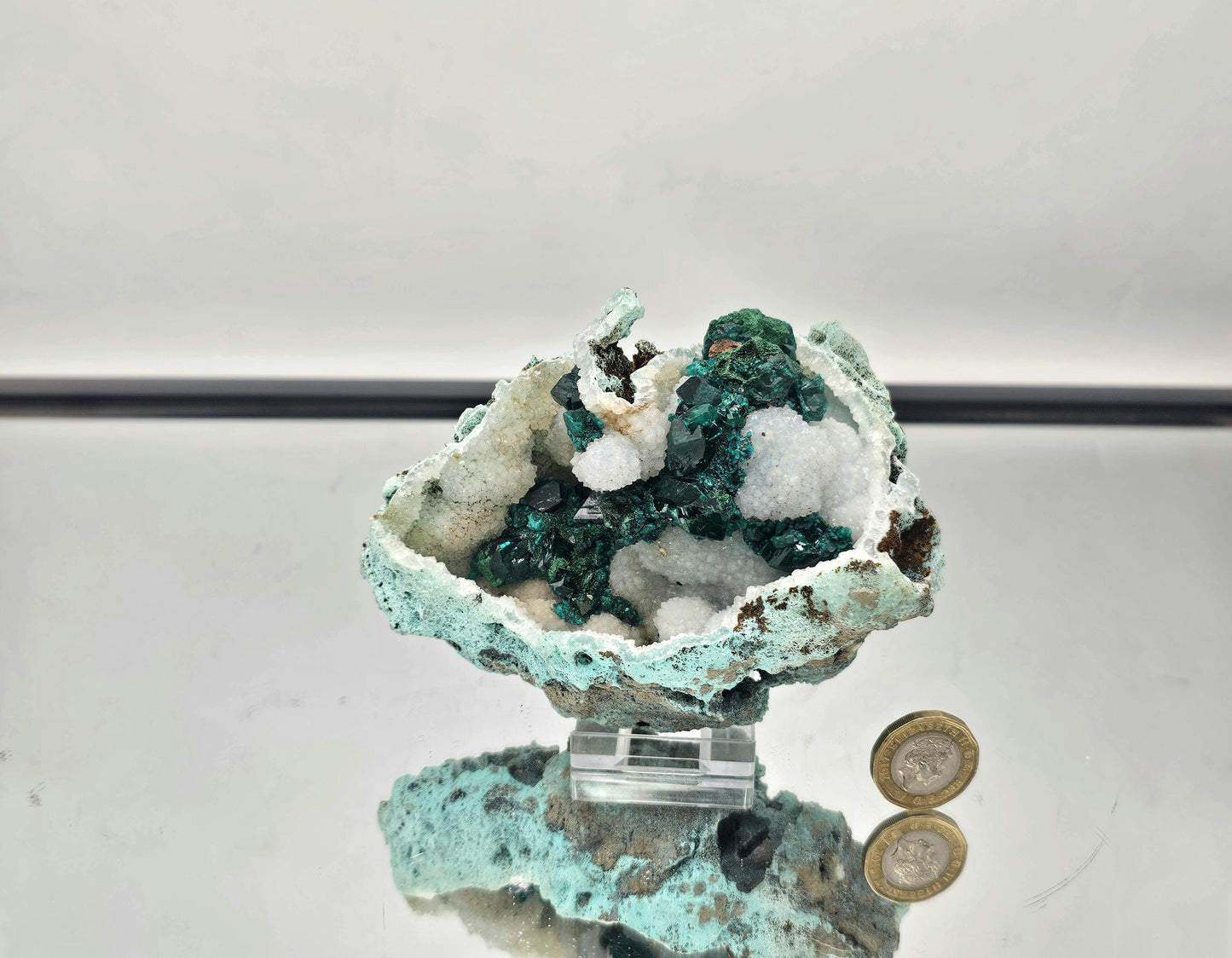 Vibrant Dioptase crystals on Quartz matrix, showcasing a stunning green color and natural mineral formation.