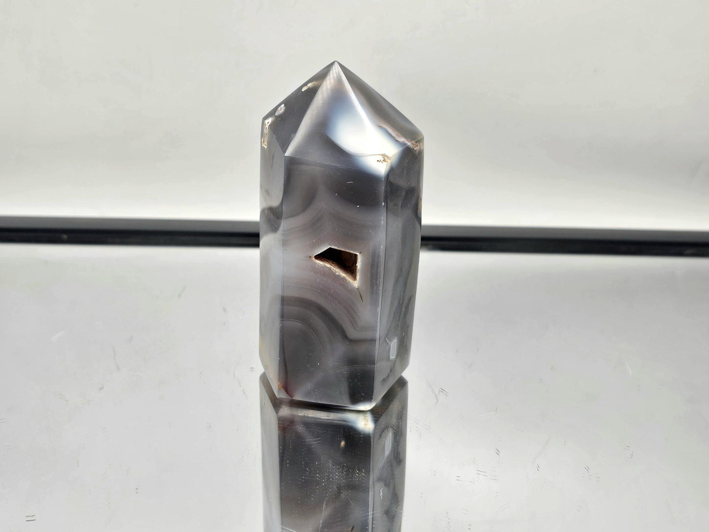 Elegant Orca Agate crystal point, perfect for energy healing.
