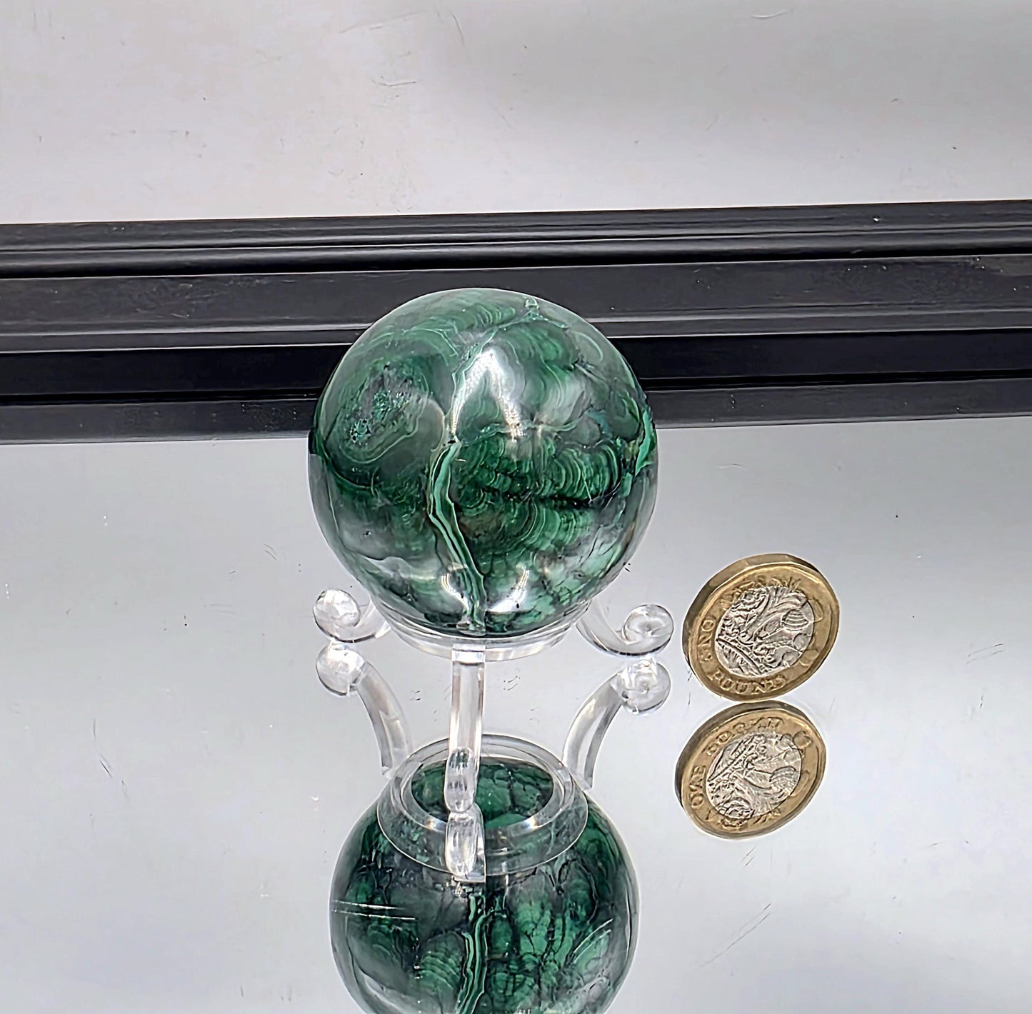 Polished floral malachite sphere crystal.