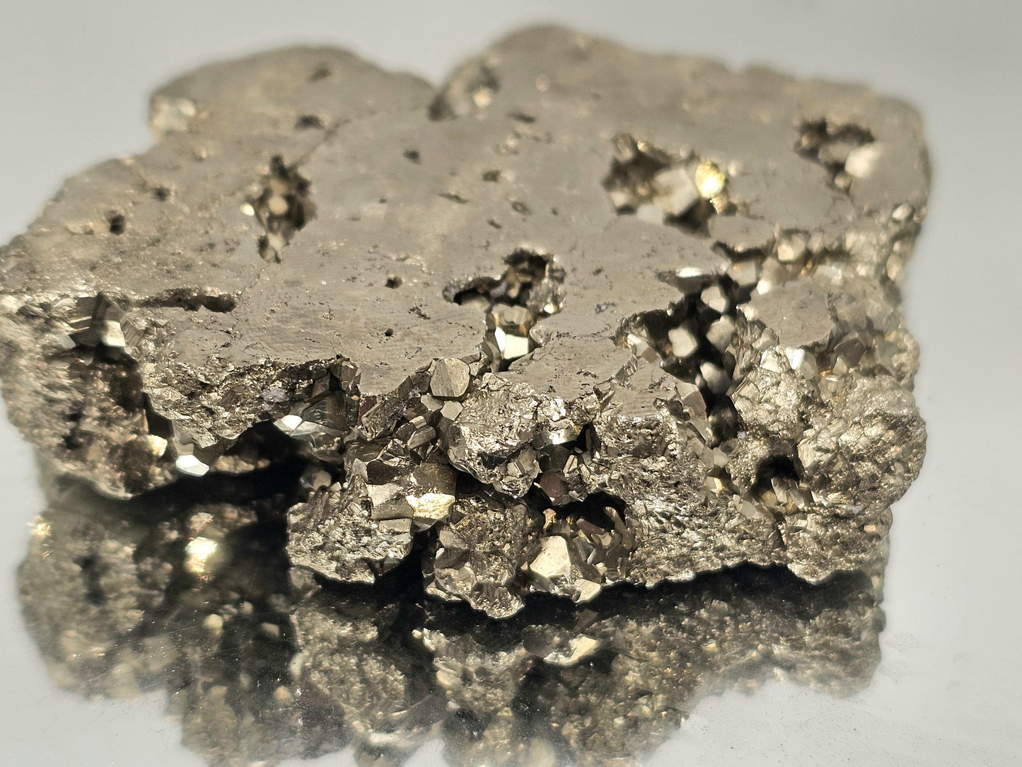 Golden Pyrite slice with a polished surface and raw edges.