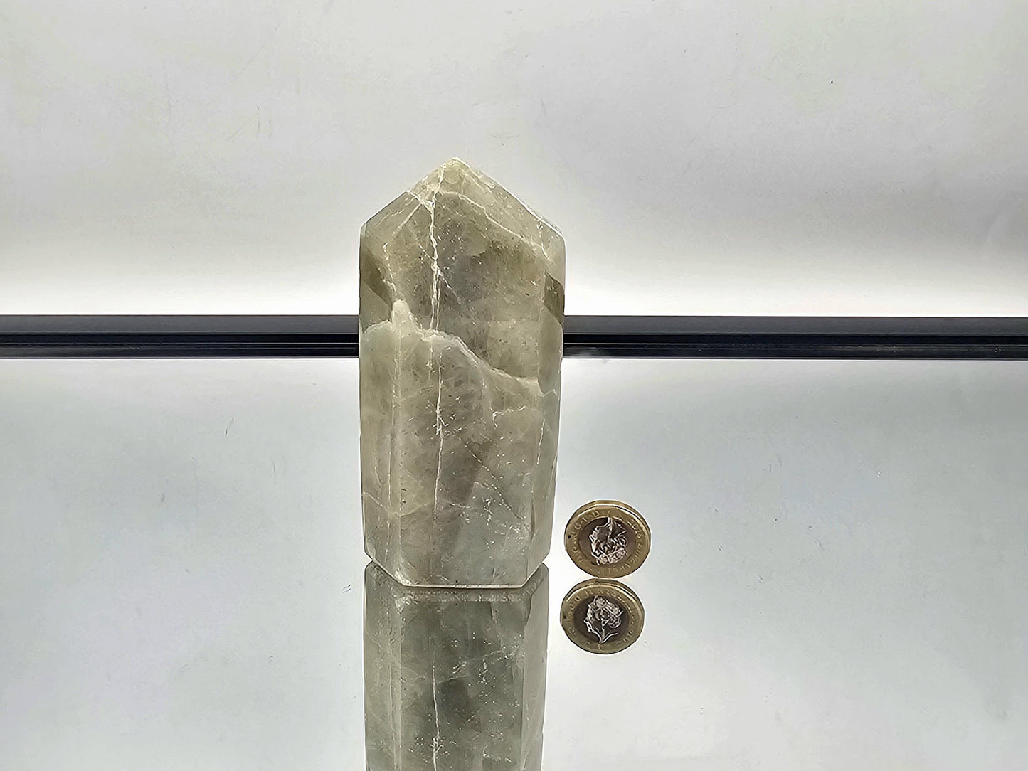 Stunning Green Moonstone crystal with garnet inclusions, a true testament to natural beauty and rarity.