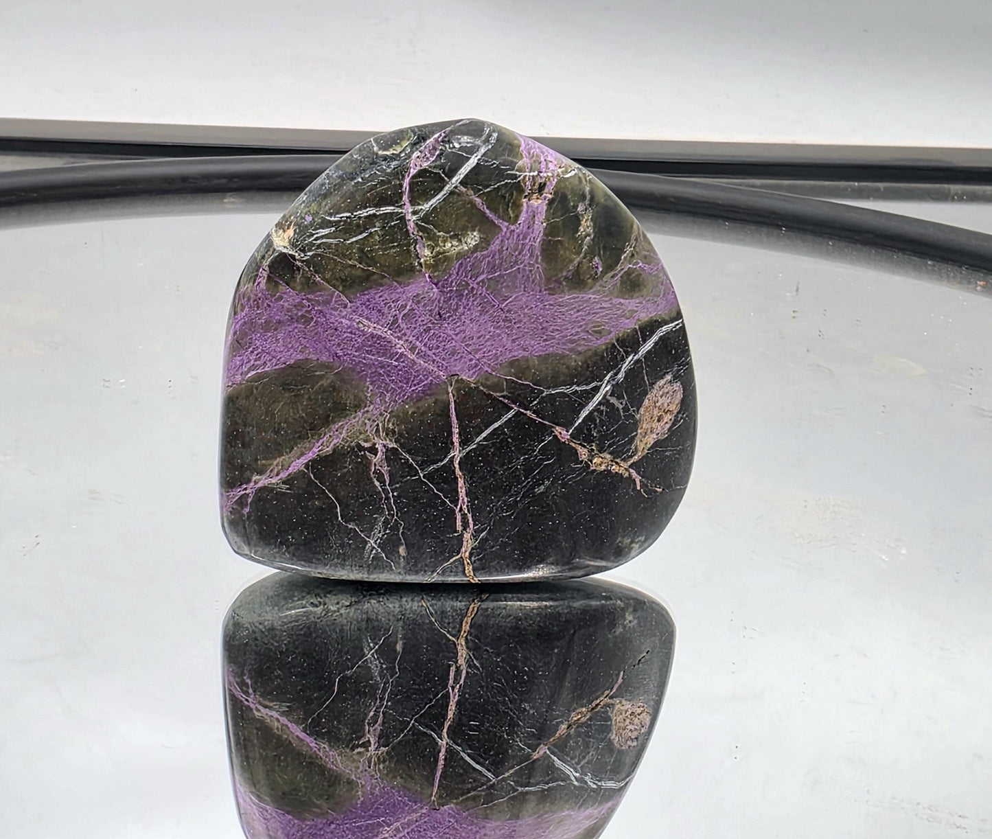 Atlantisite stone with natural contrast of green and purple.