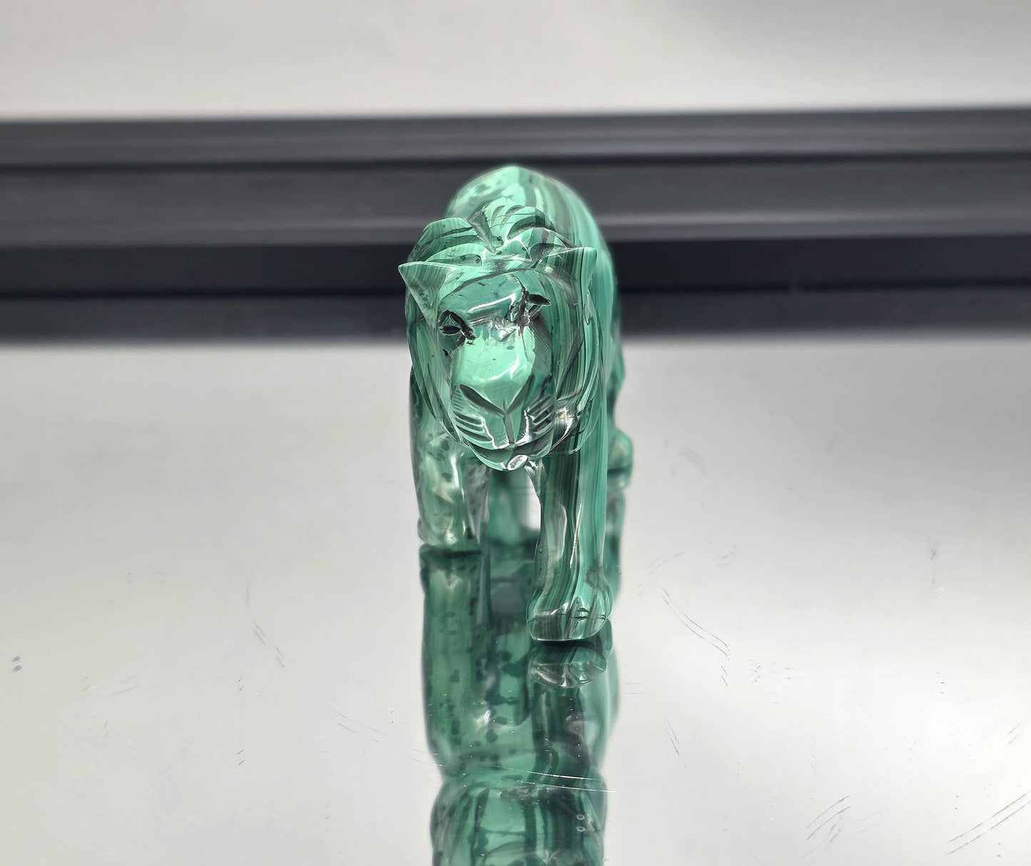 Detailed craftsmanship in green malachite, featured in an open-plan space.