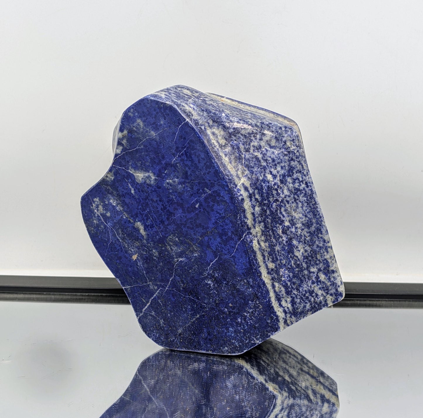Freeform gemstone of Lapis Lazuli polished to reveal natural beauty.