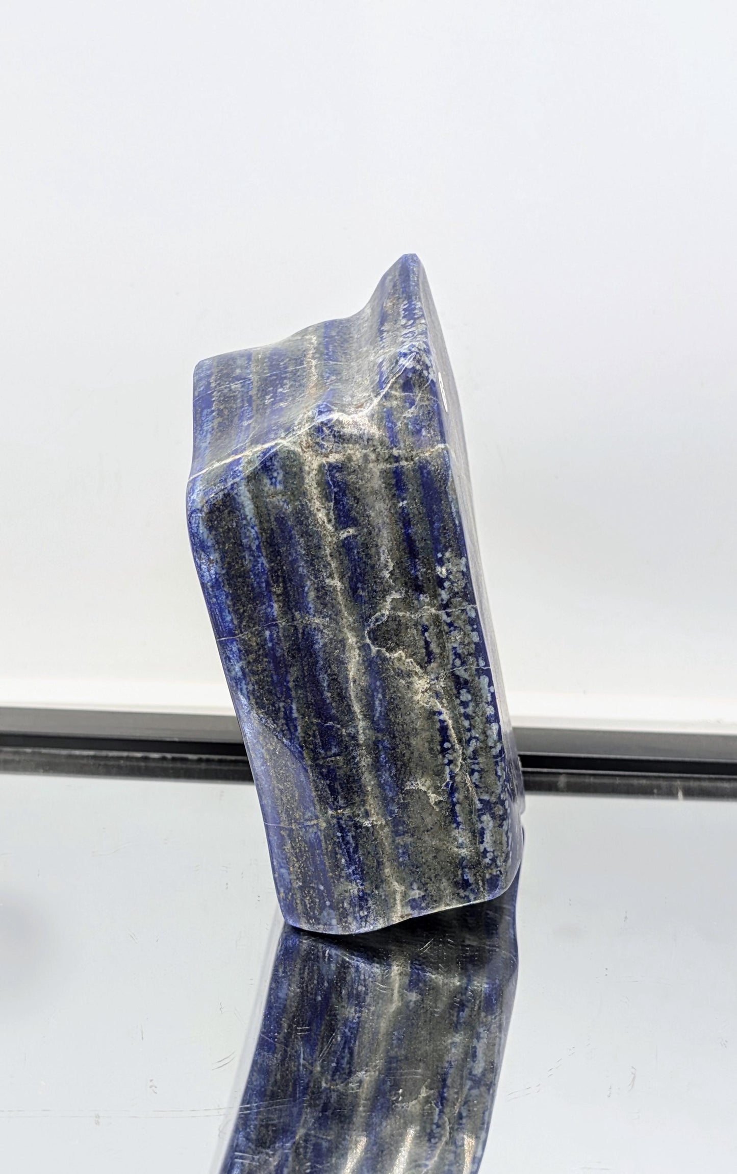 Deep blue Lapis Lazuli with freeform cut and polished surface.