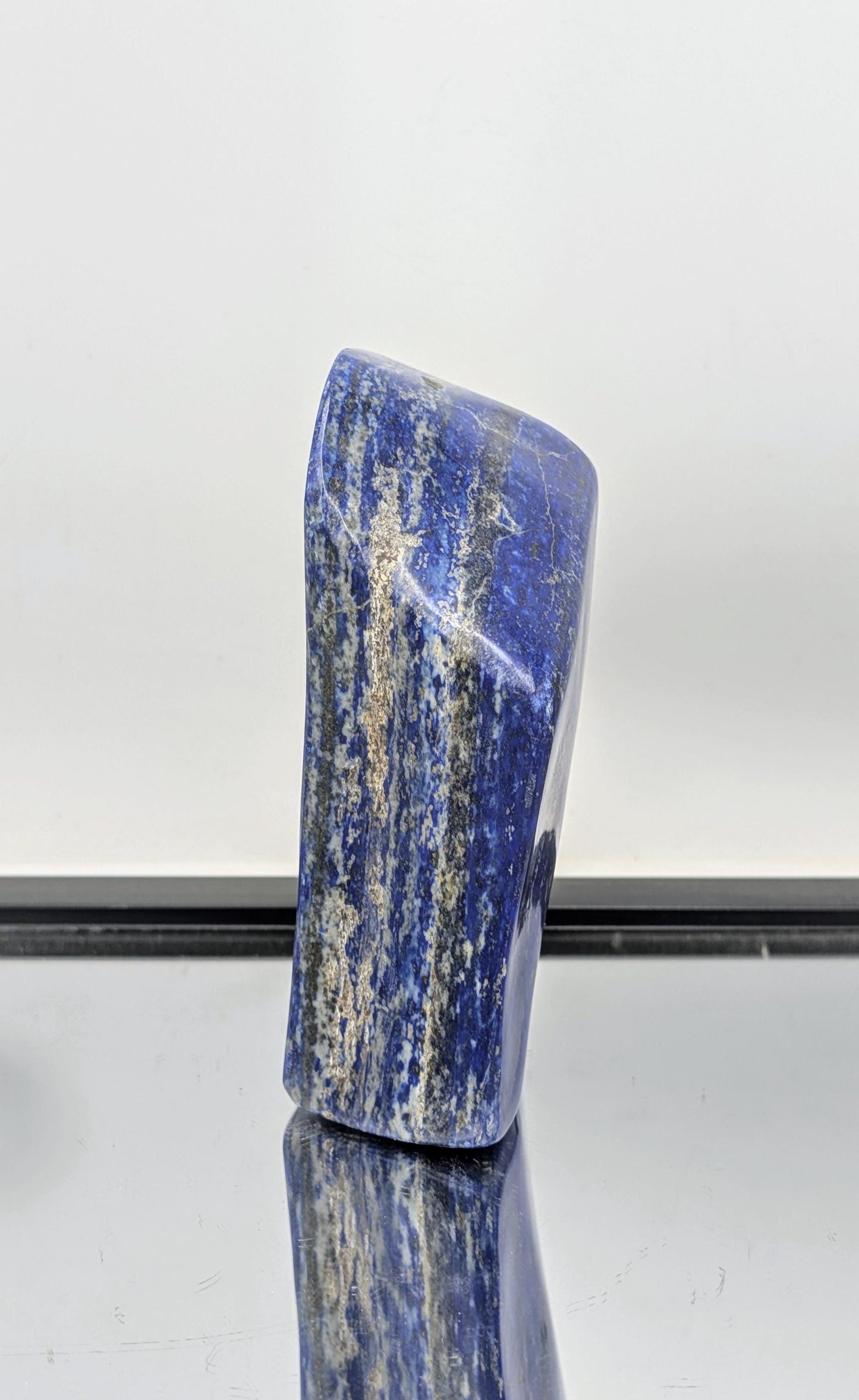 Freeform Lapis Lazuli stone with vibrant blue and gold veins.