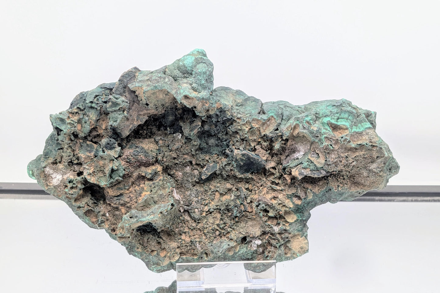 Substantial malachite specimen adorned with quartz druzy crystals.