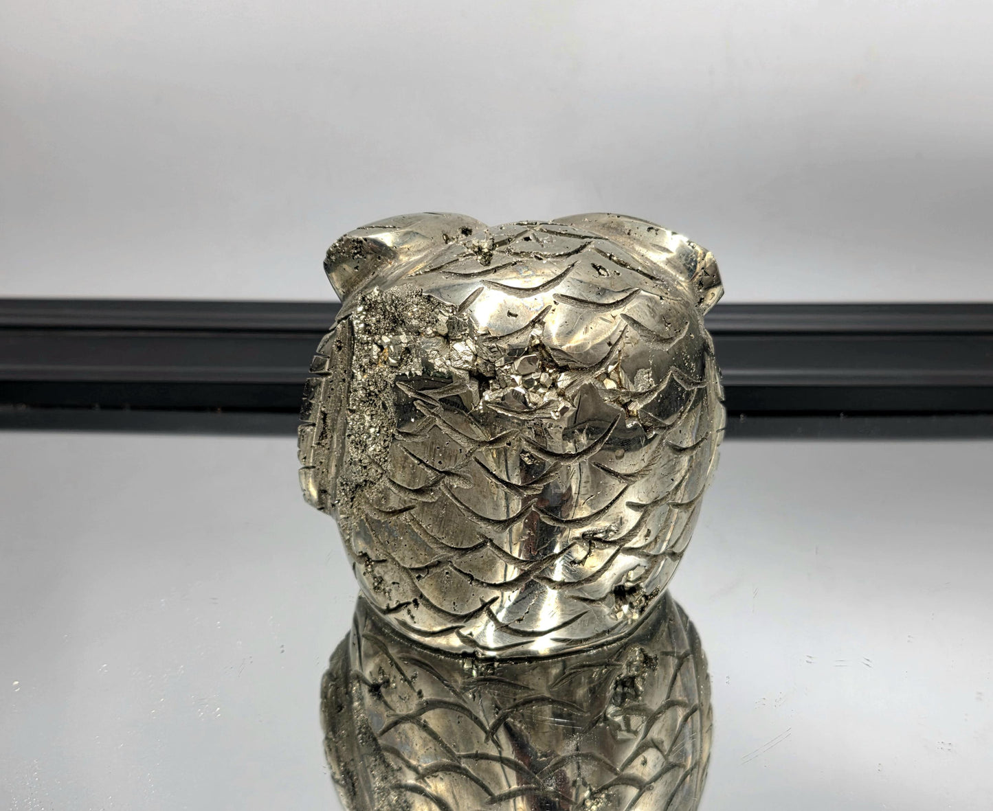 Shimmering crystal owl carved from natural pyrite