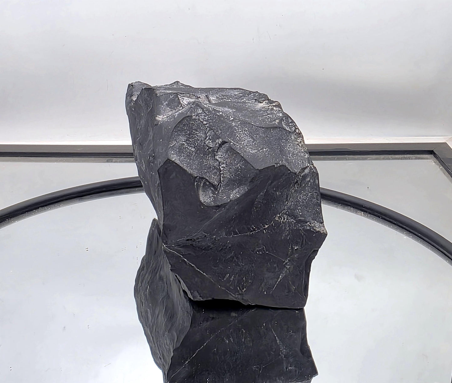 Substantial shungite crystal featuring natural mineral inclusions.