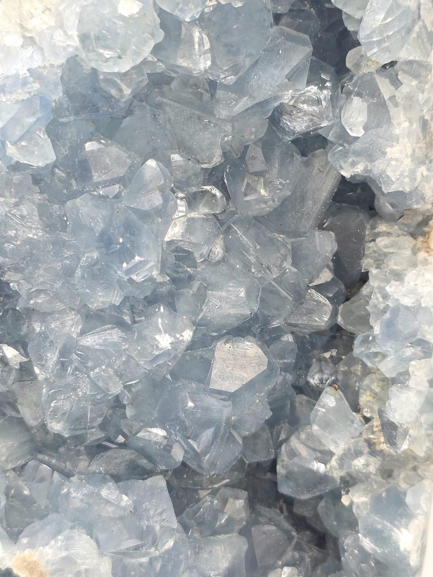Close-up of Celestite crystal points showing intricate detail and translucent blue color.