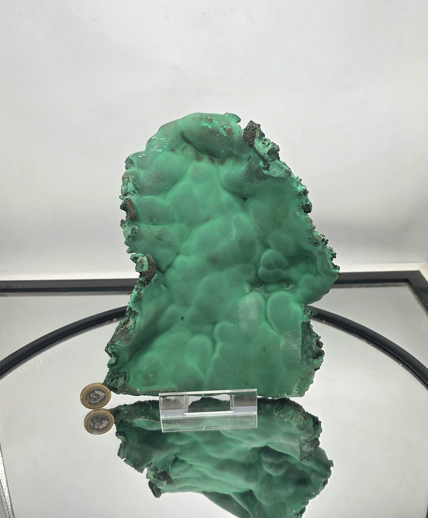 Decorative malachite plate perfect for display, highlighting its natural raw beauty.