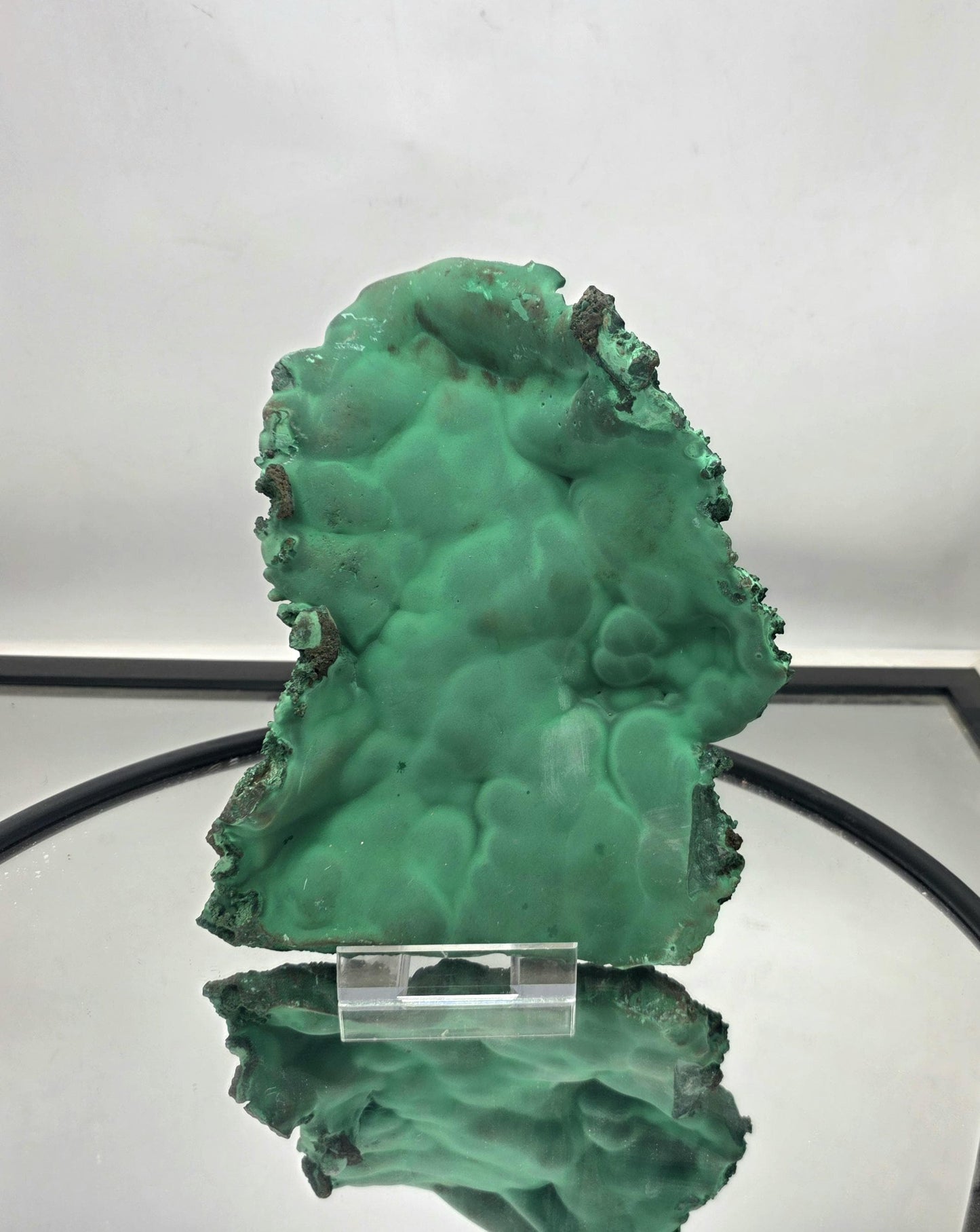 A large malachite crystal plate in its natural and raw state.