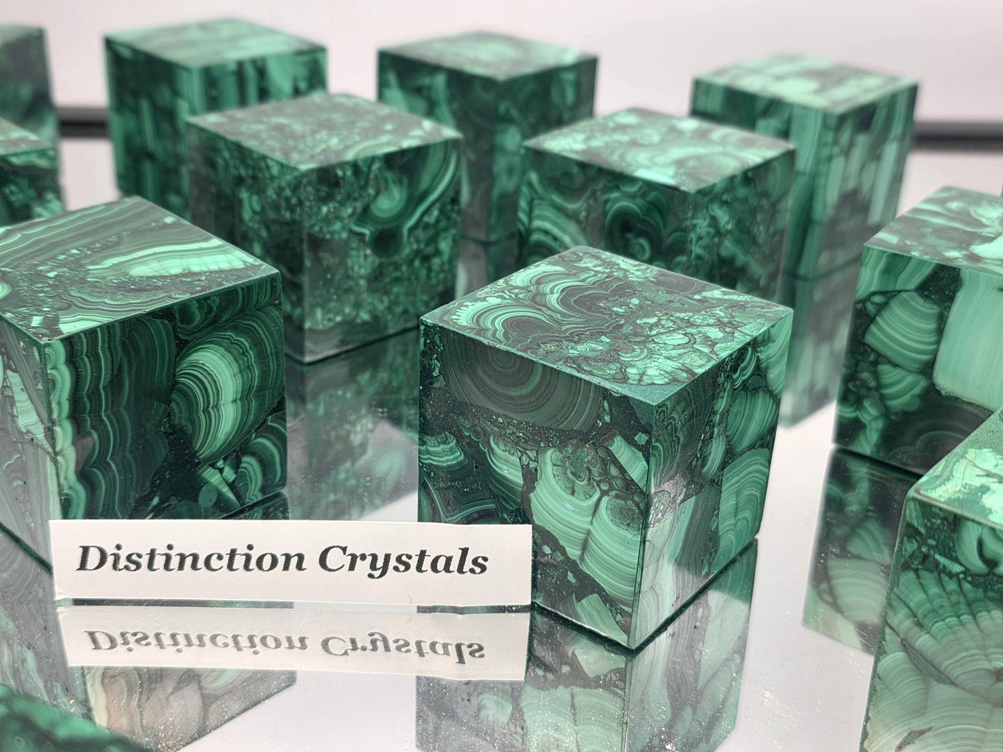 Large Malachite cube displayed in premium interior setting.