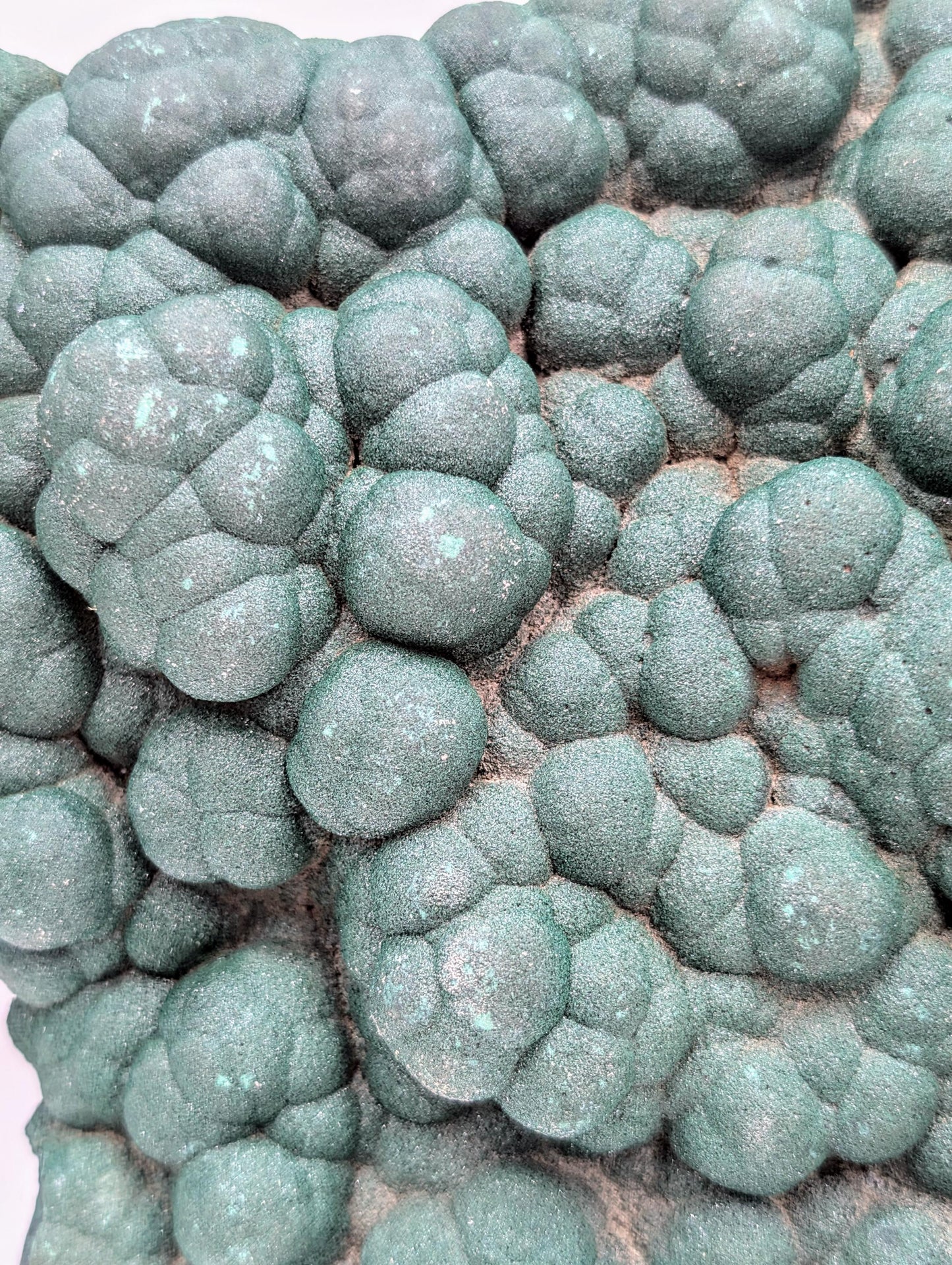 High-quality malachite crystal featuring natural quartz druzy.