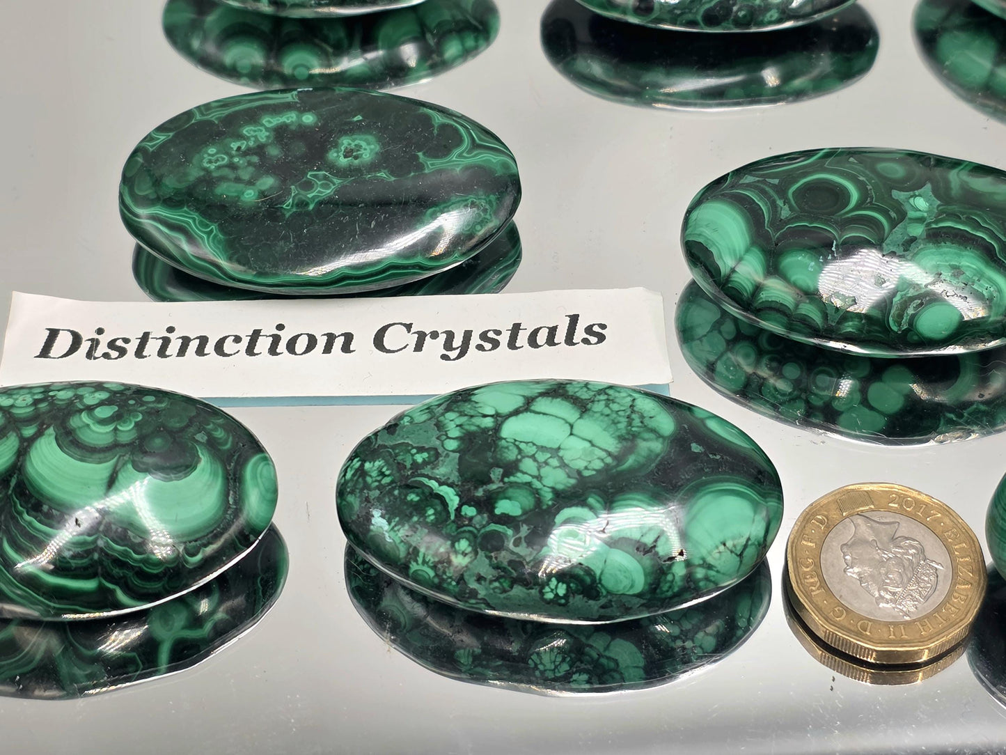 Malachite palmstone showing vibrant green banding.