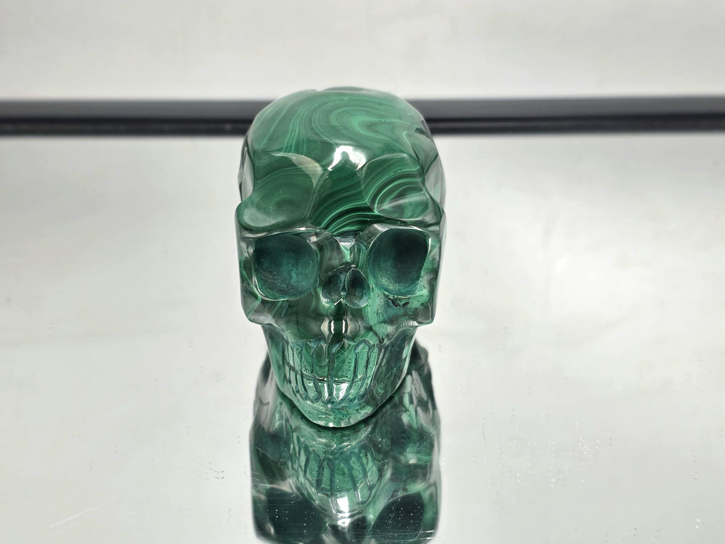 Malachite skull showing detailed natural banding.