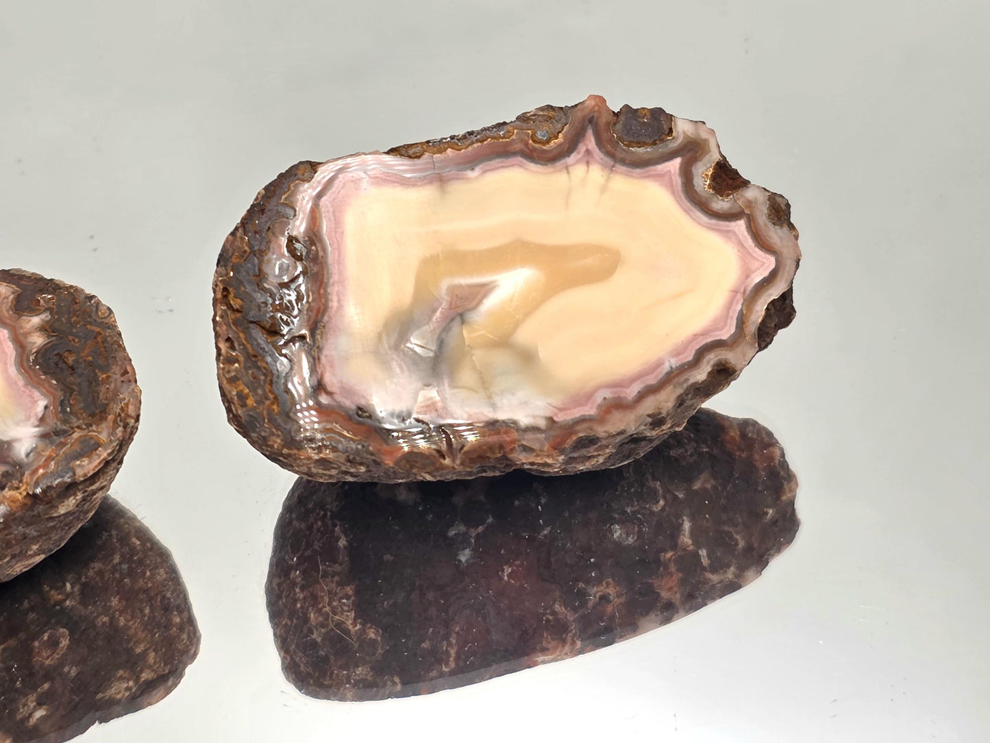 Malawi Agate polished geode pair for display.