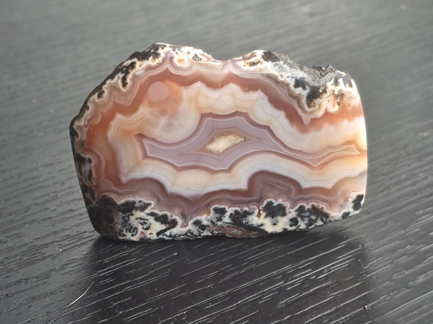 Moroccan agate with bold black edges and vibrant banding.