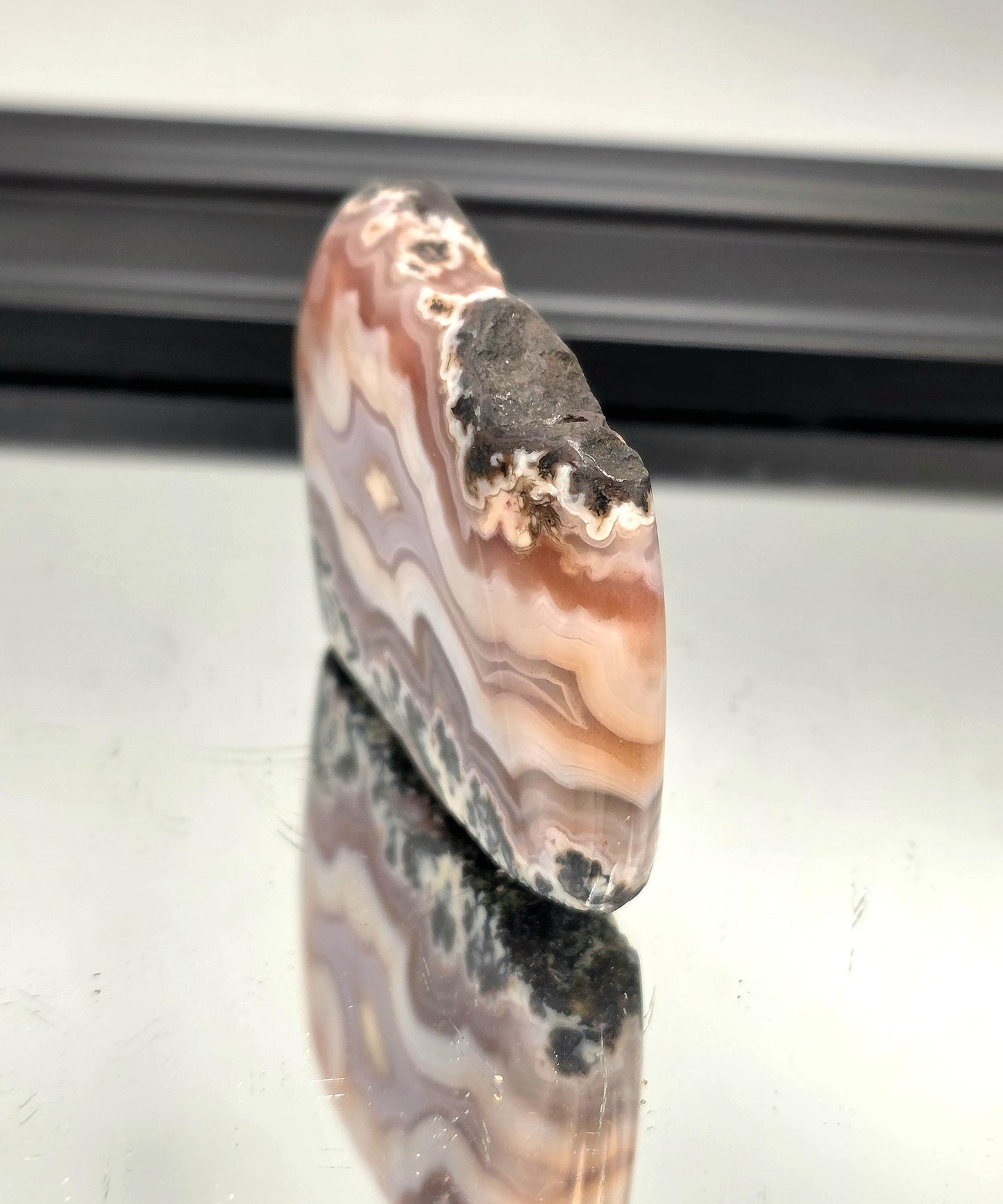 Natural agate slice showing soft lavender and cream layers from Aouli, Morocco.