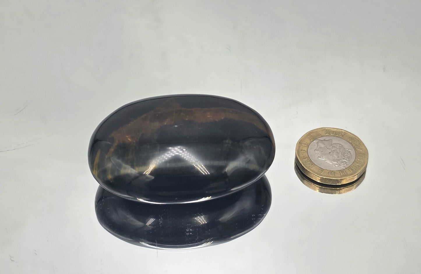 Naturally polished palmstone crafted for hand use and display.