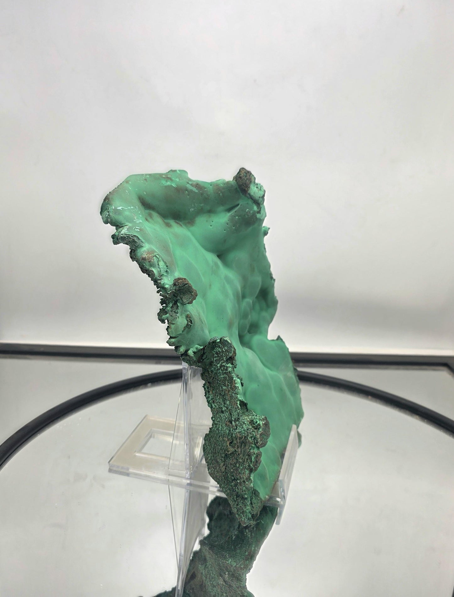 Raw malachite crystal plate with distinctive and rich coloration.
