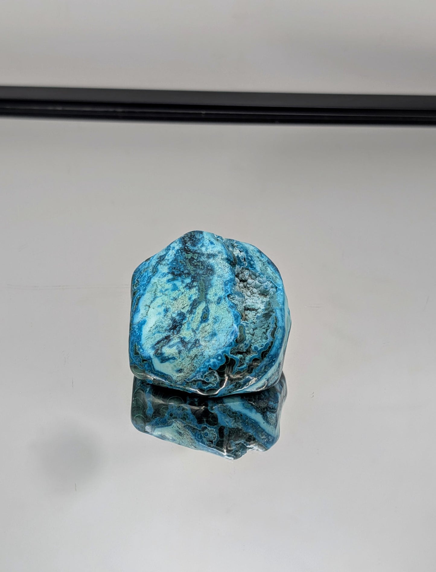 Natural freeform Malacolla crystal in deep green and blue tones.