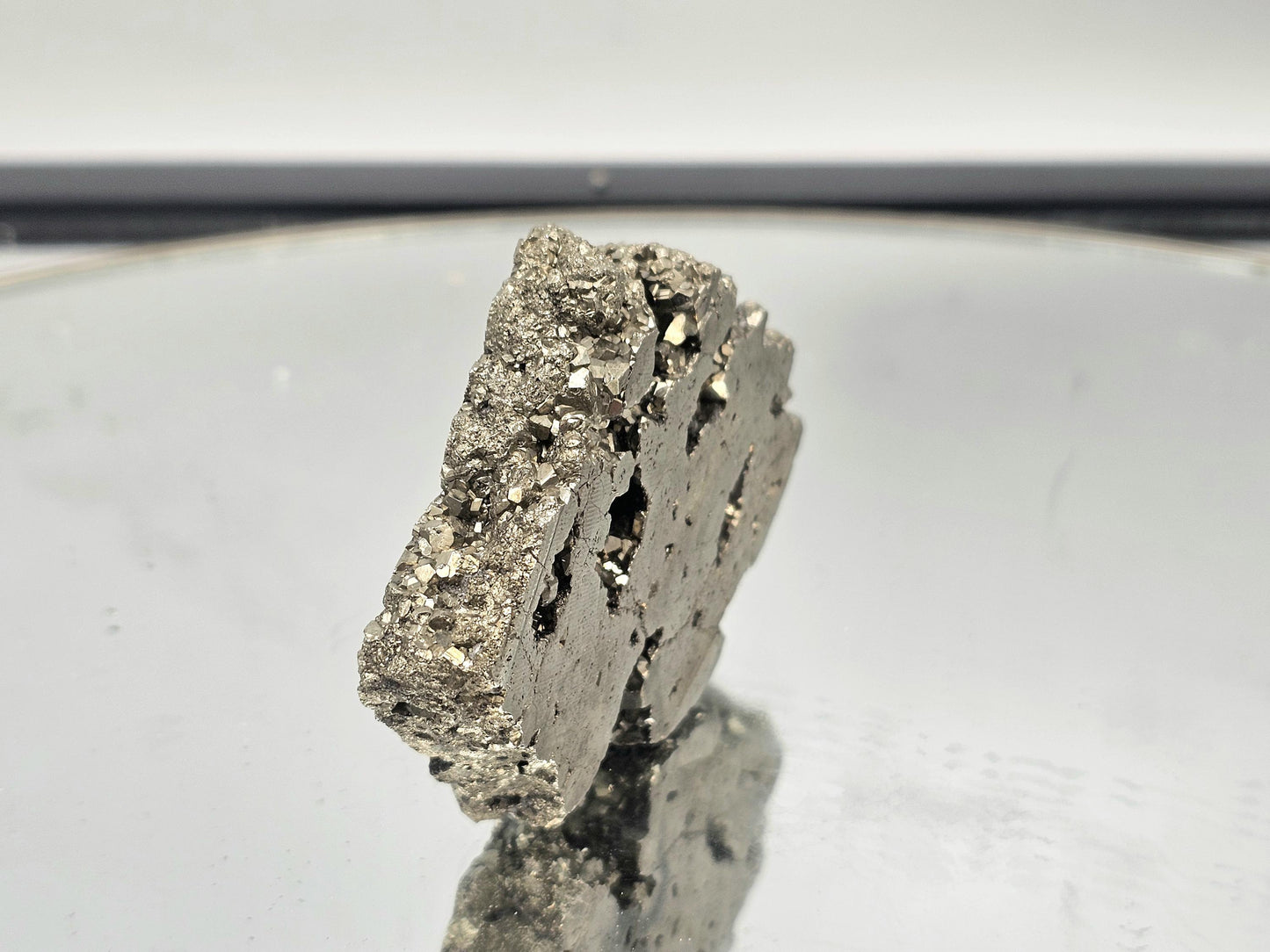 Natural Pyrite crystal slice with a shimmering gold finish.