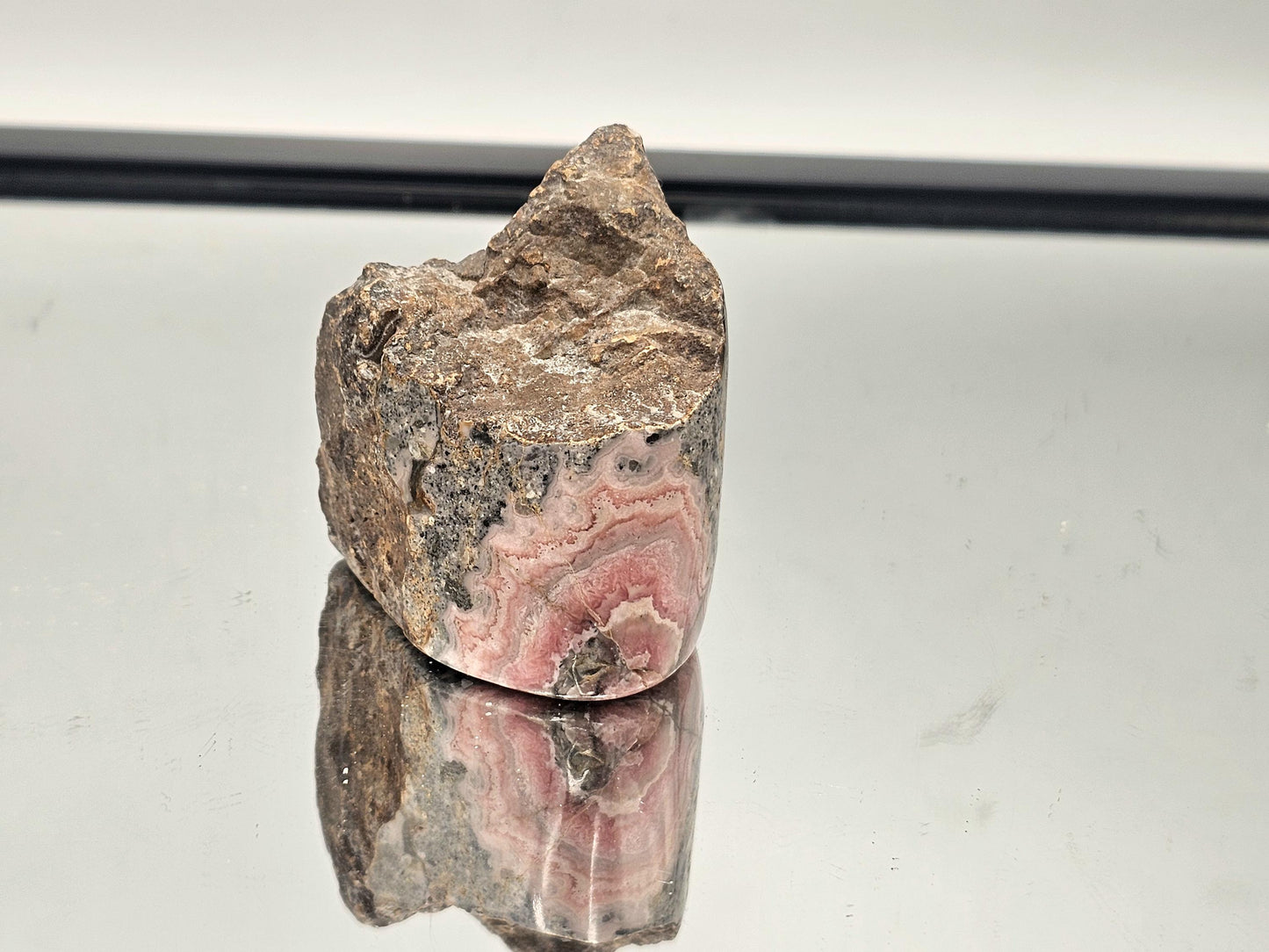 Polished Pink Rhodochrosite in its natural matrix, a beautifully balanced and unique crystal piece.