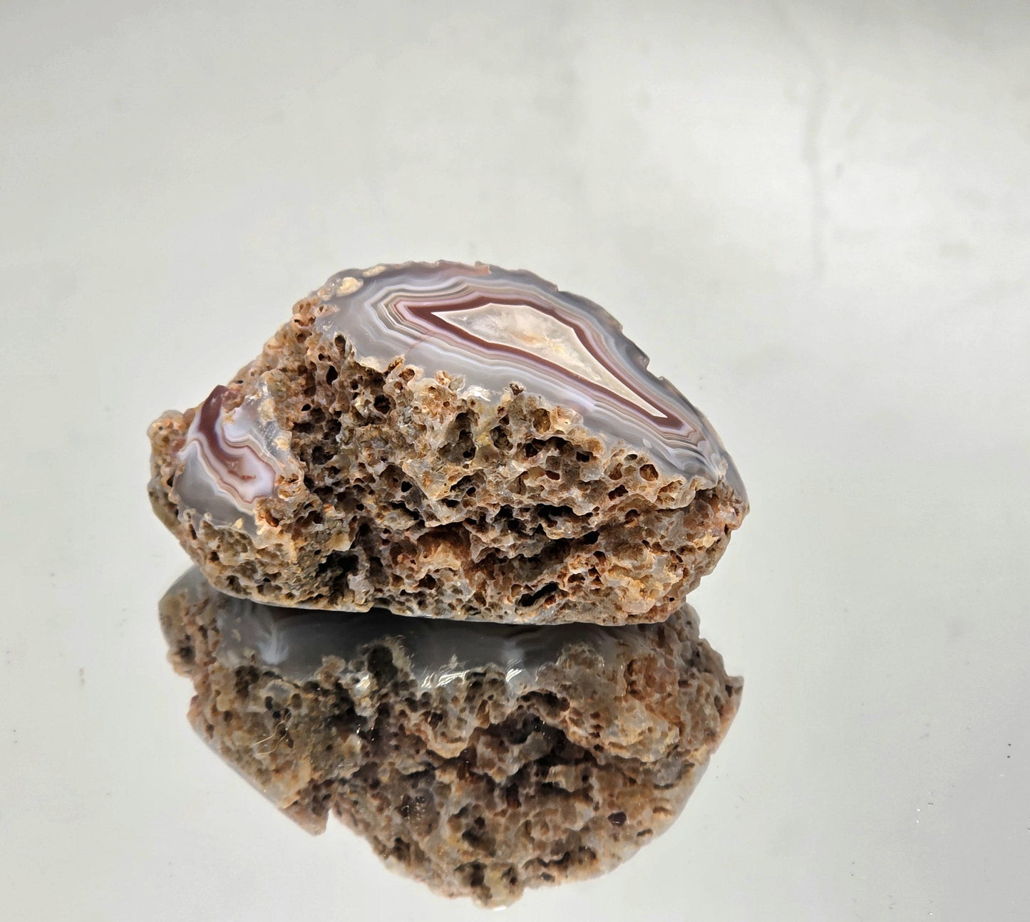 Polished Malawi Agate crystal geode with colour bands.