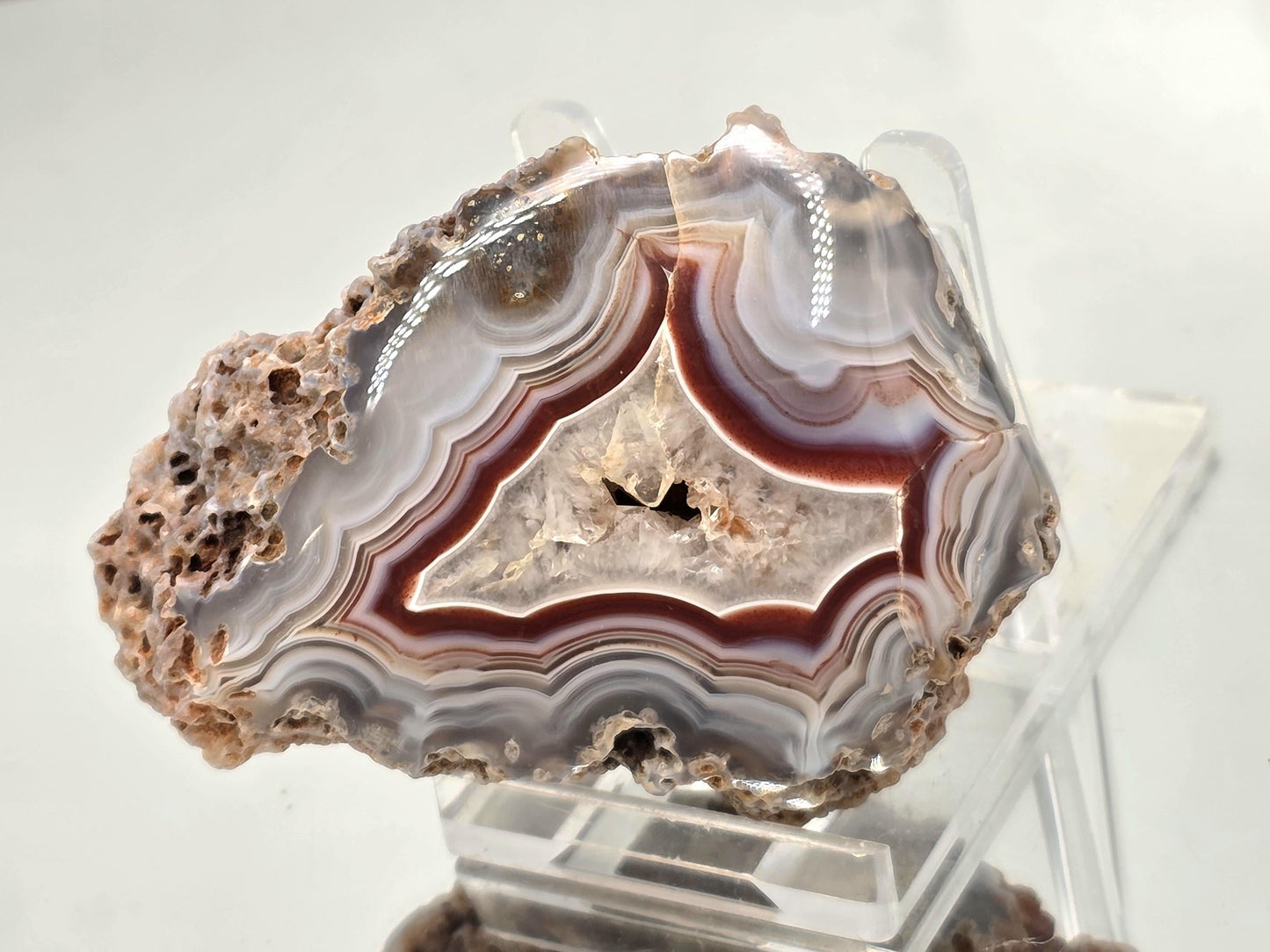 Polished Malawi Agate geode with vivid banded patterns.