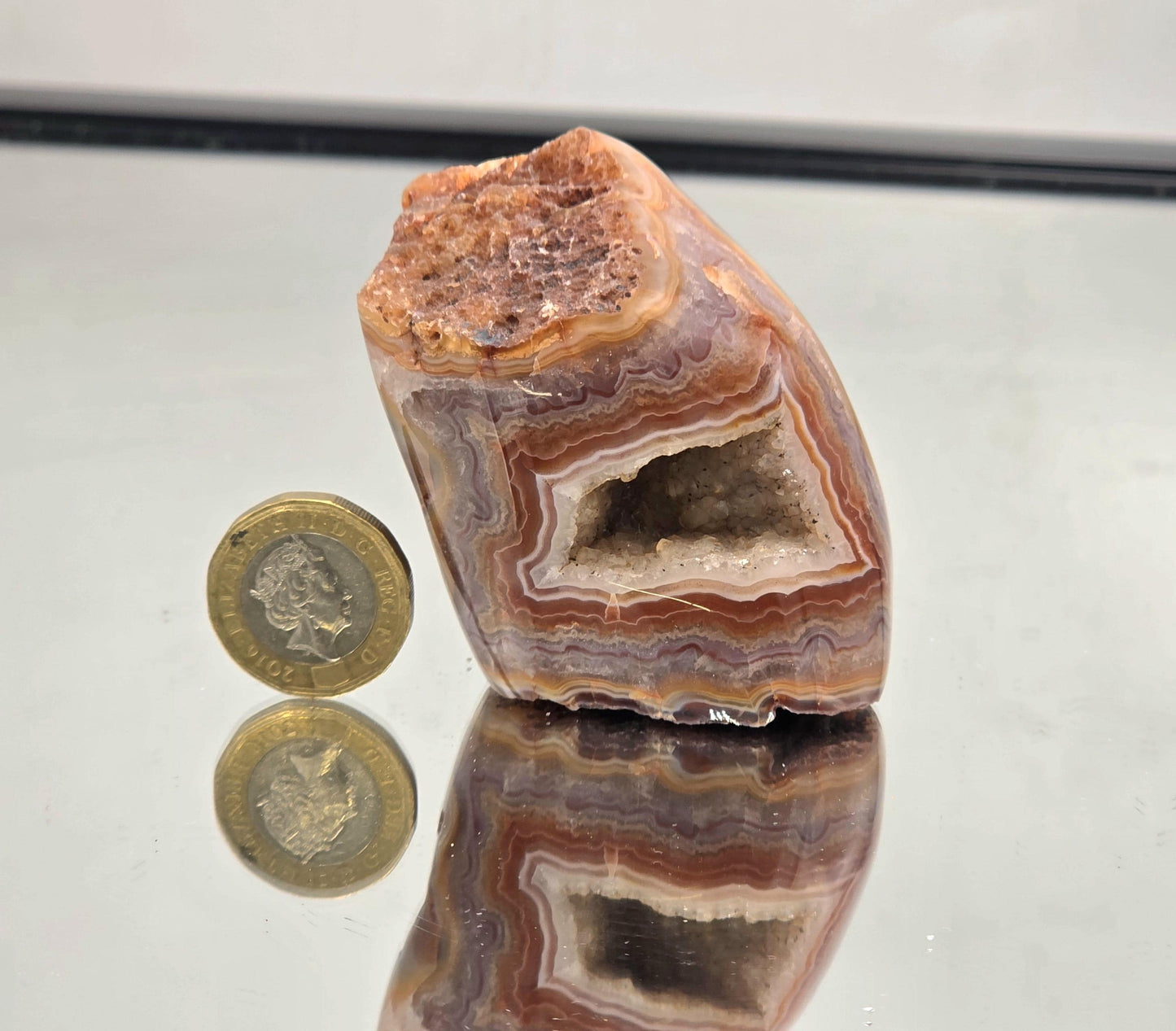 Polished Malawi Agate geode crystal with bands.
