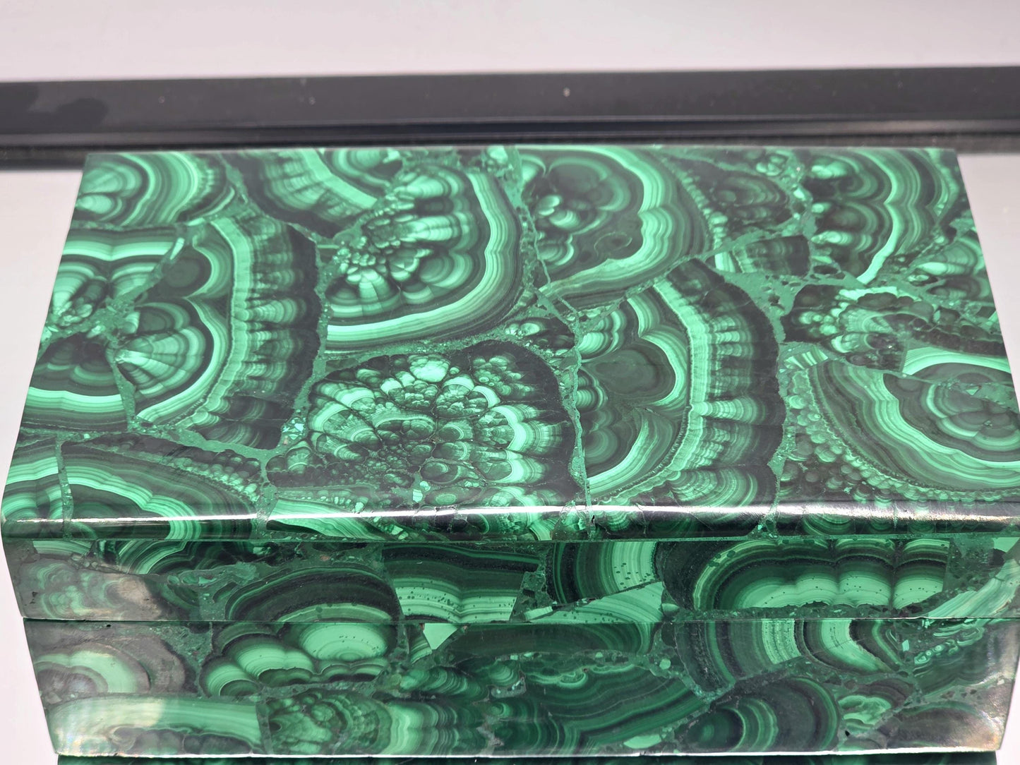 A polished Malachite box with a luxurious high-gloss finish.