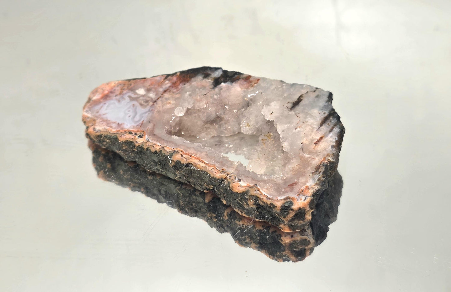 Polished Pink Agate slice from Morocco with vibrant bands.