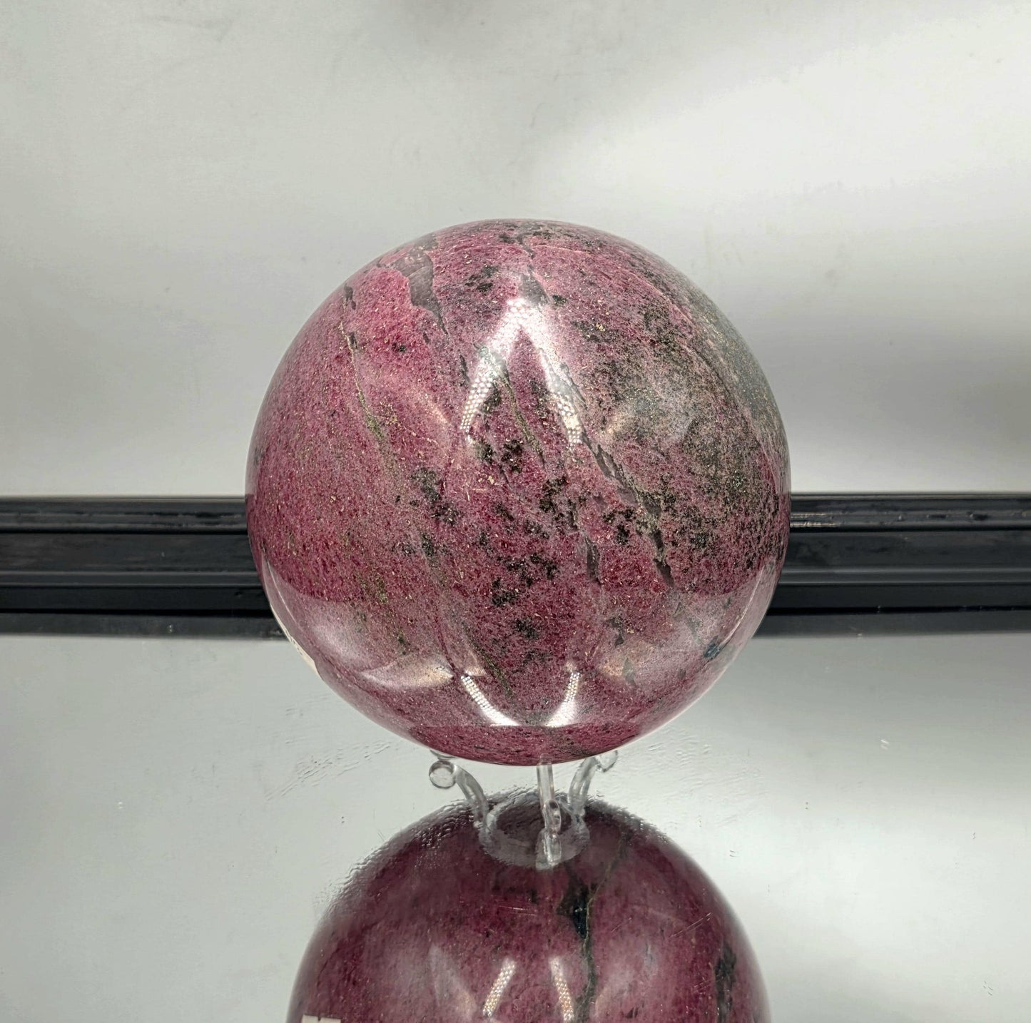 High-polish rhodonite sphere perfect for collectors.