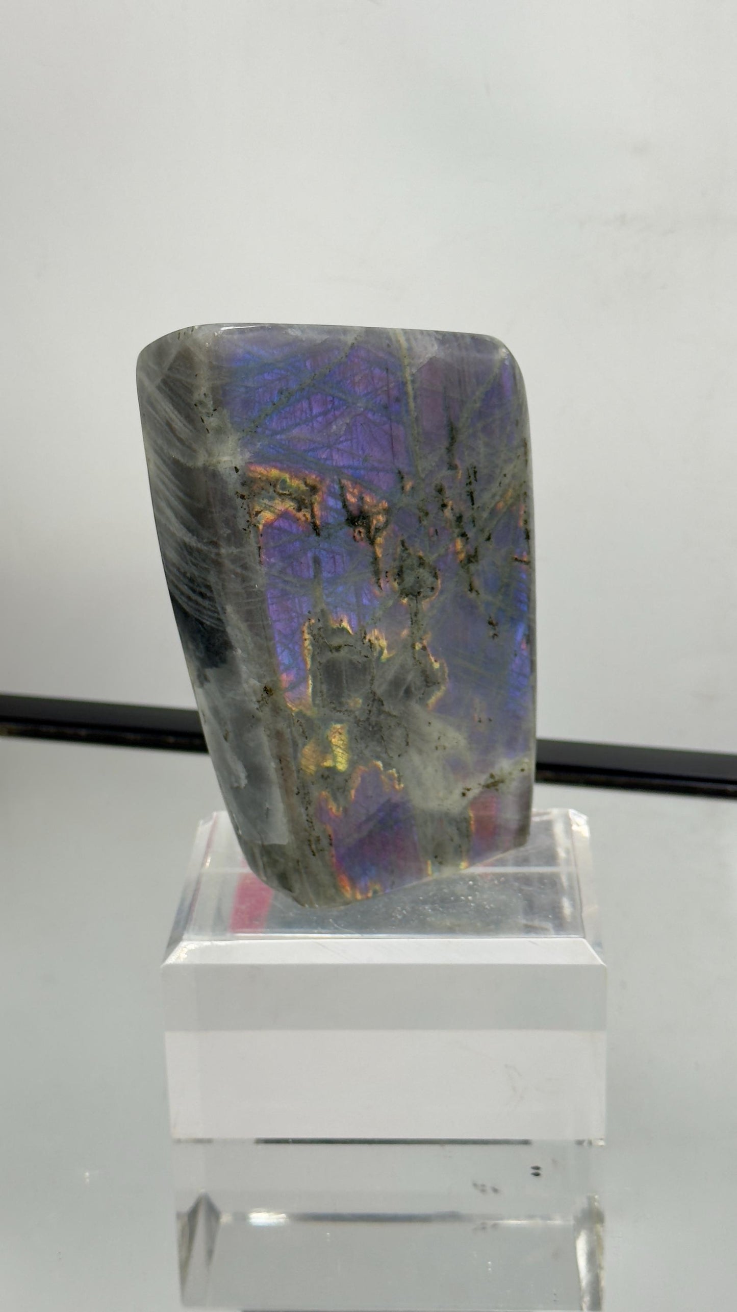 Stunning polished purple Labradorite gemstone with bright violet and blue flash – unique collector’s piece.