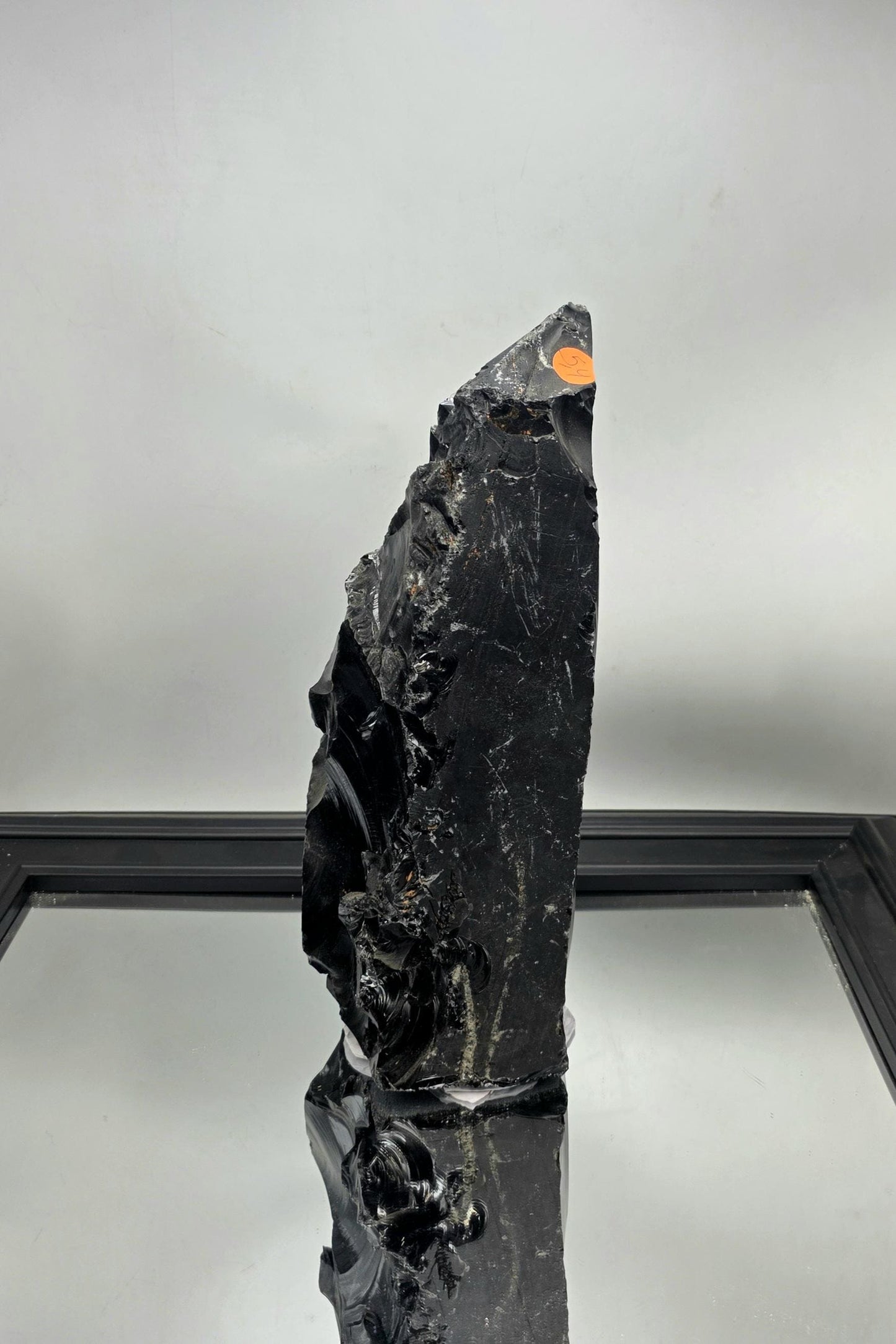 Large natural obsidian styled among luxury decor items