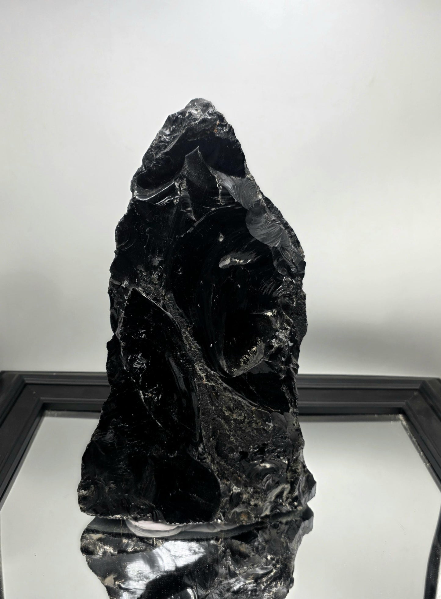 Raw stone decor piece used to anchor a shelf styling layout.