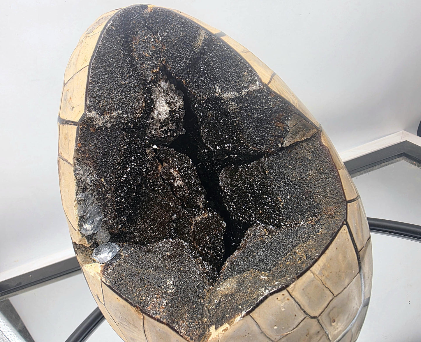 Septarian crystal egg featuring intricate internal designs.